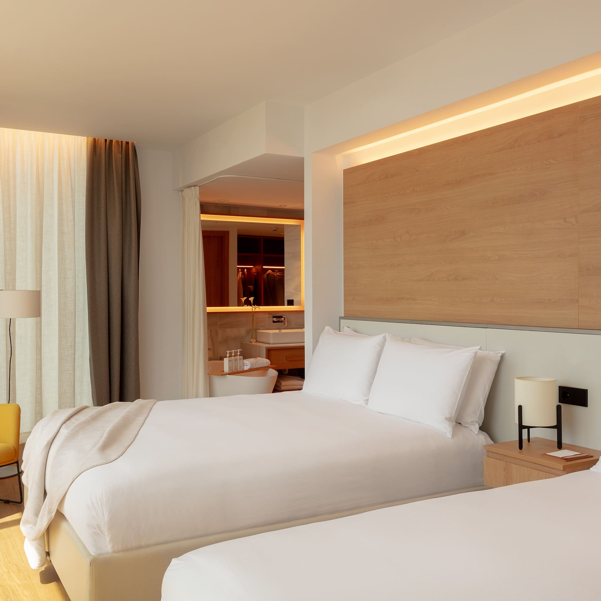 a bedroom with a bed and a tub