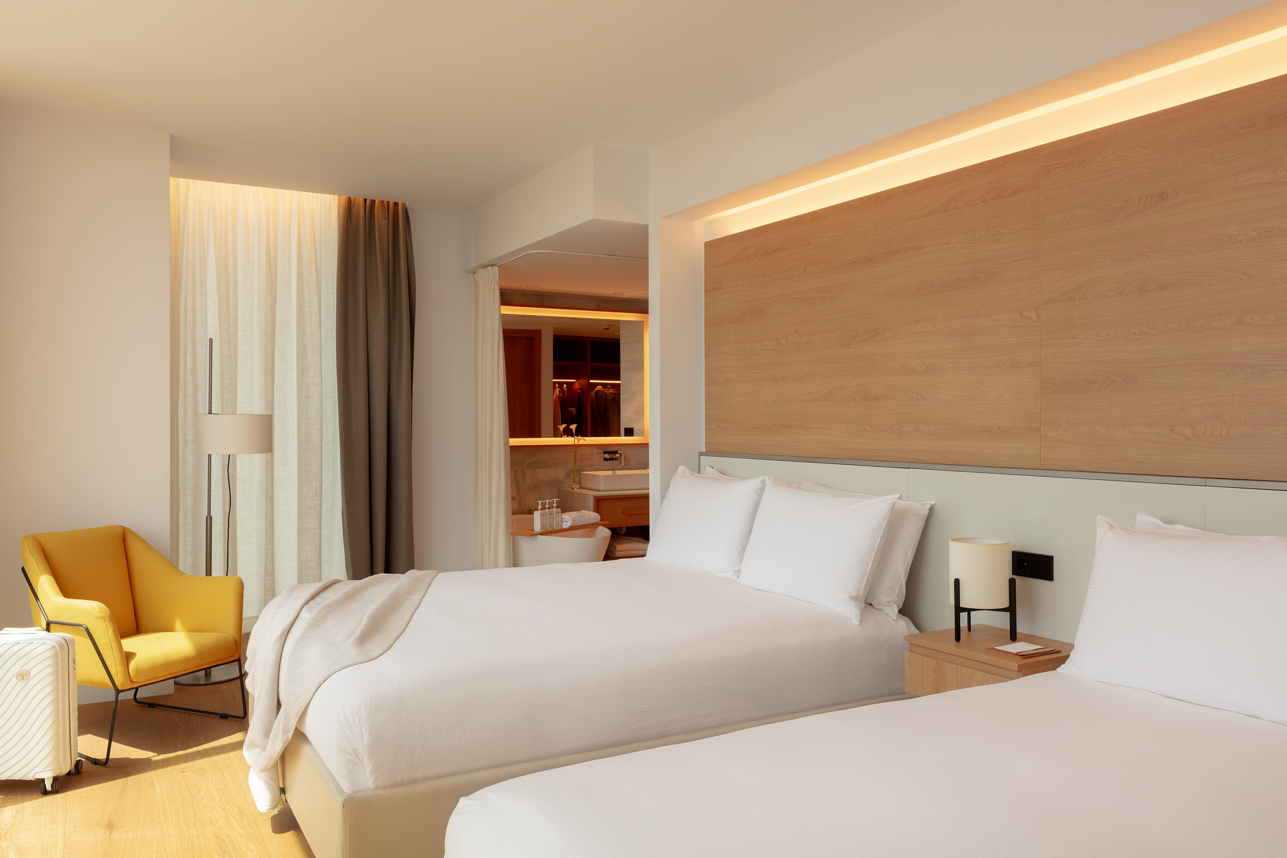 a bedroom with a bed and a tub