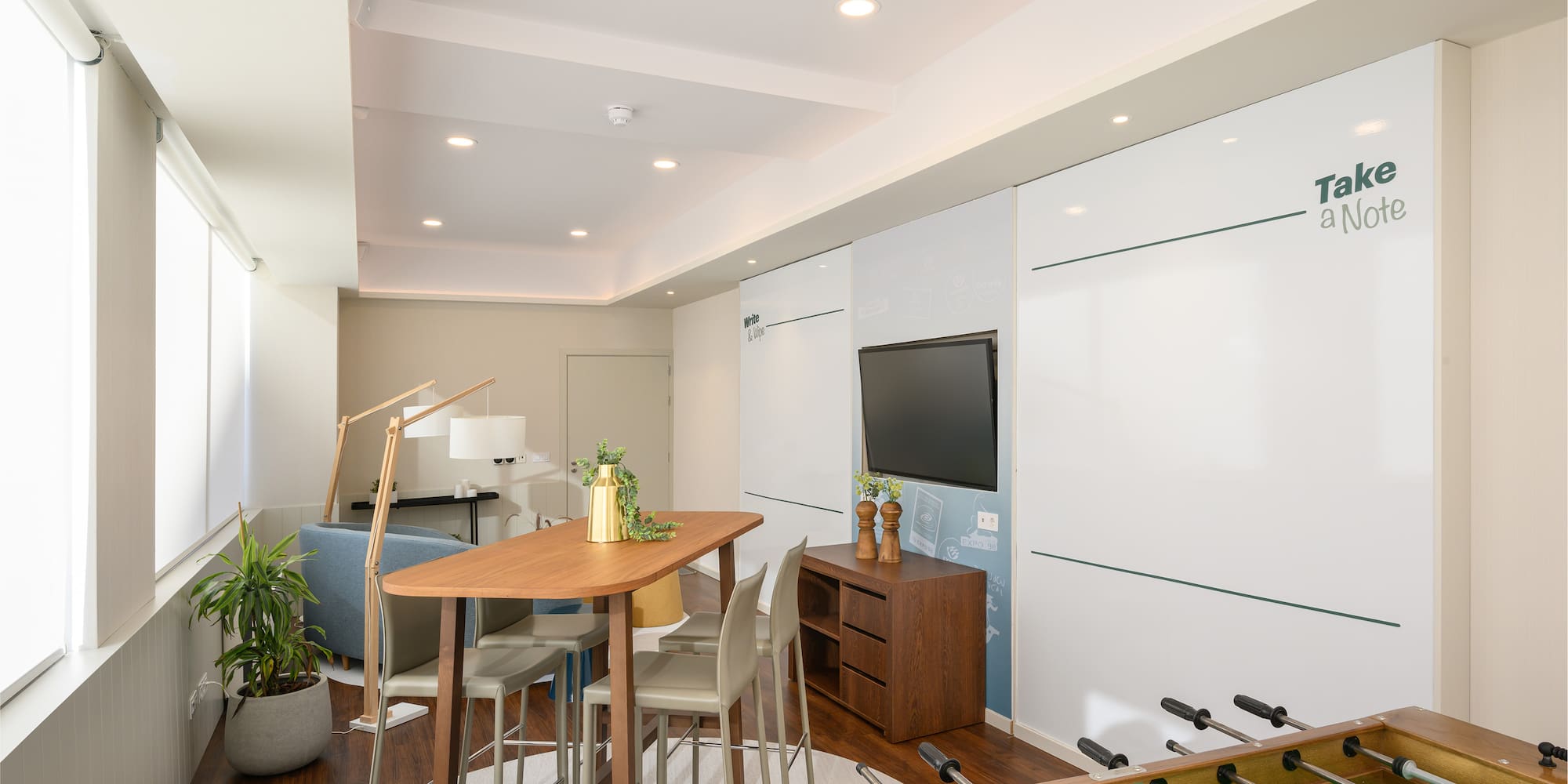 a room with a table and foosball table