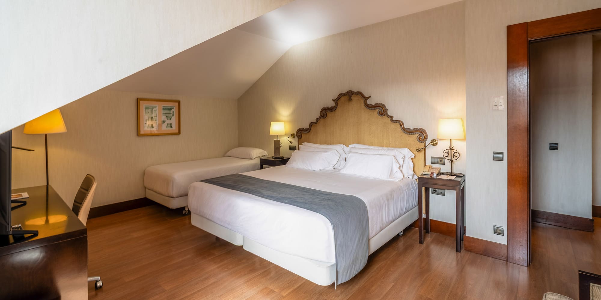 a bedroom with a bed and two beds