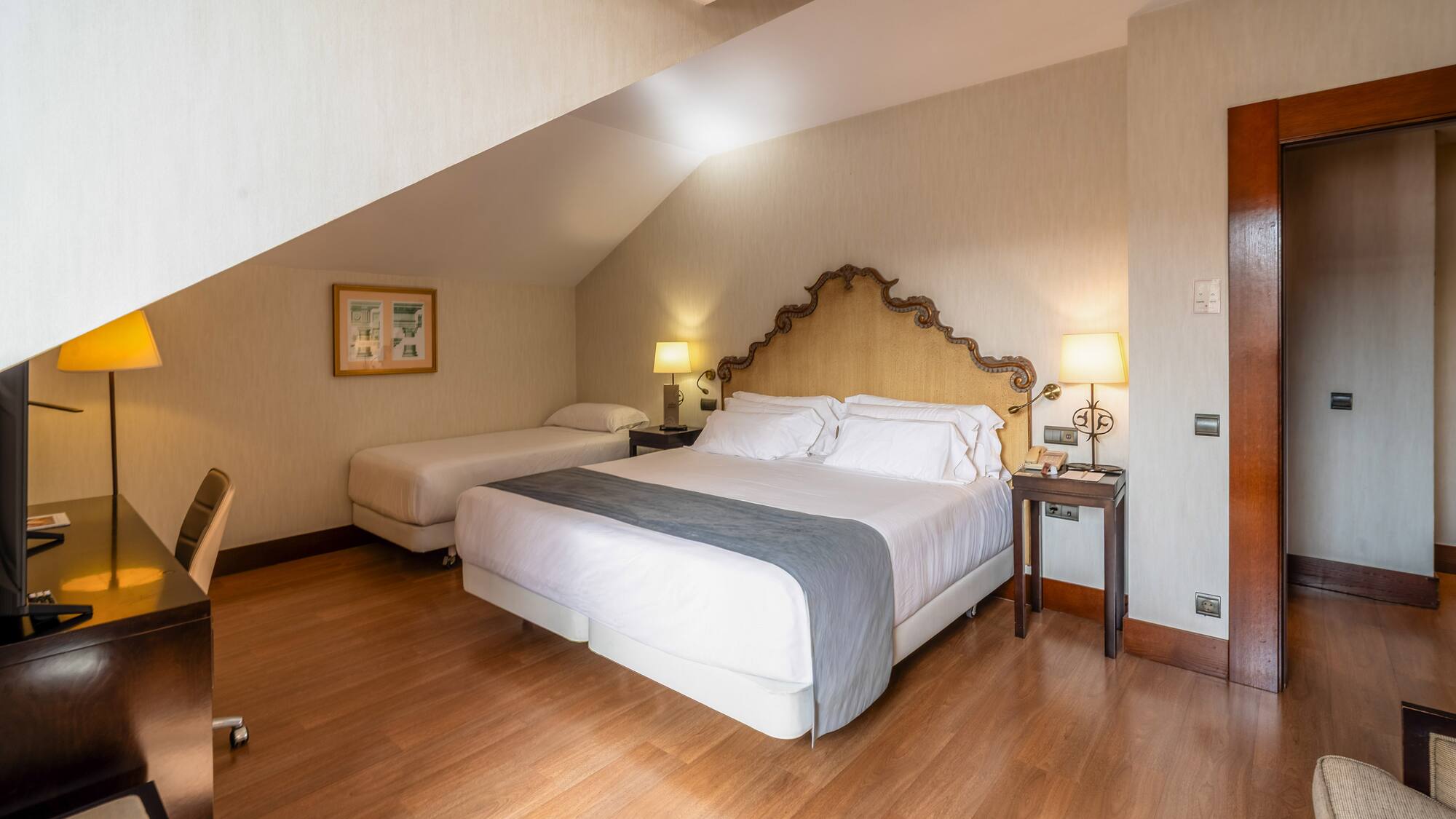 a bedroom with a bed and two beds