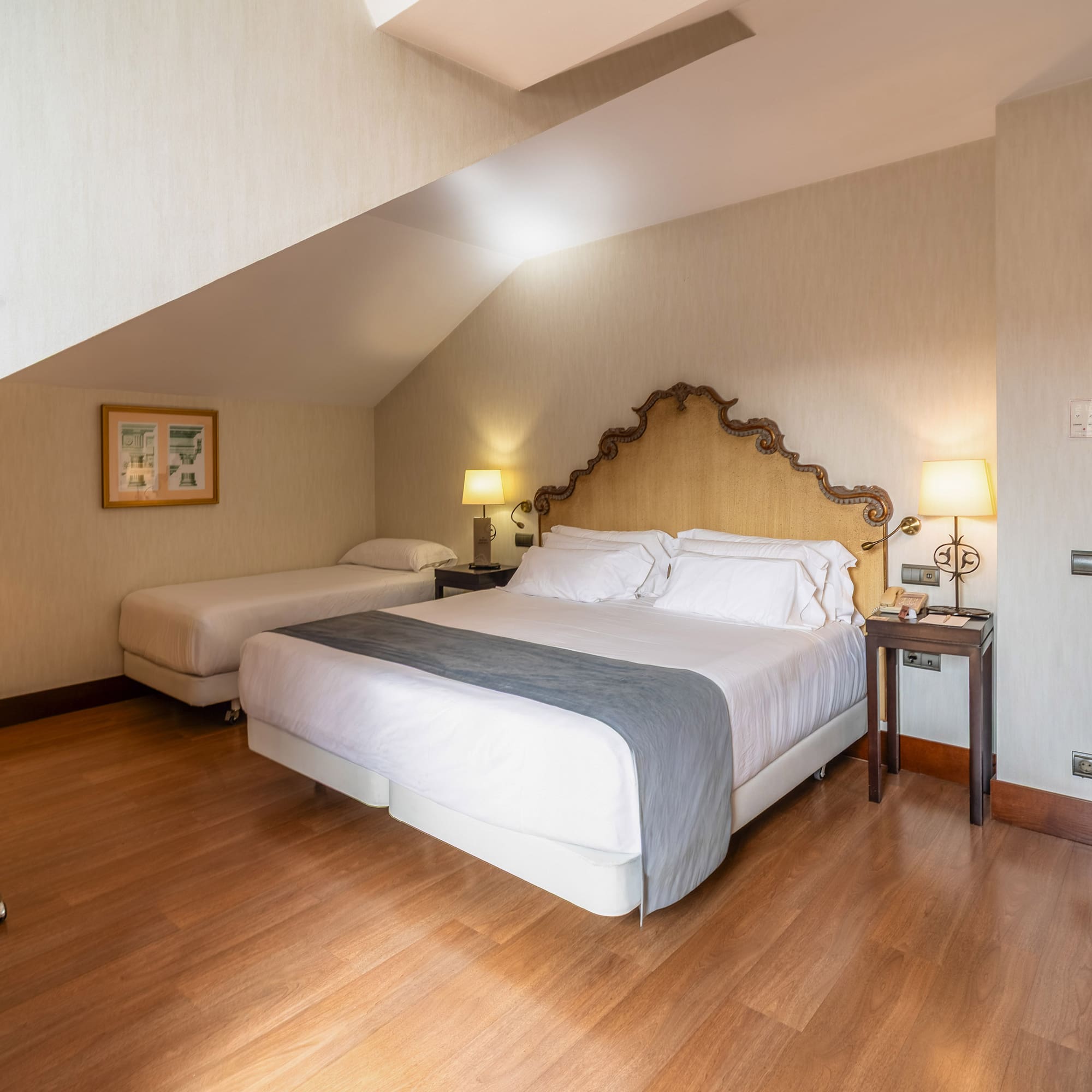 a bedroom with a bed and two beds