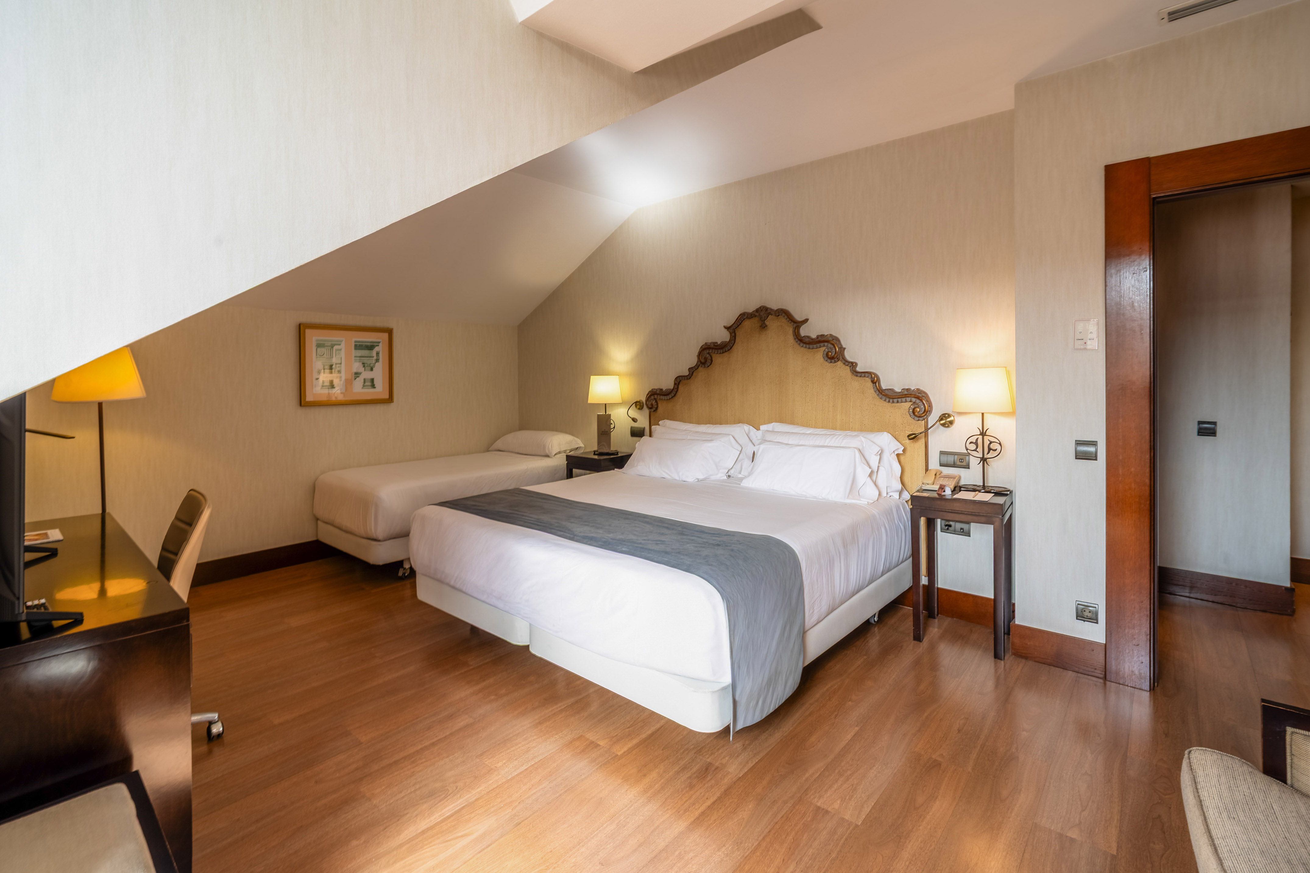 a bedroom with a bed and two beds