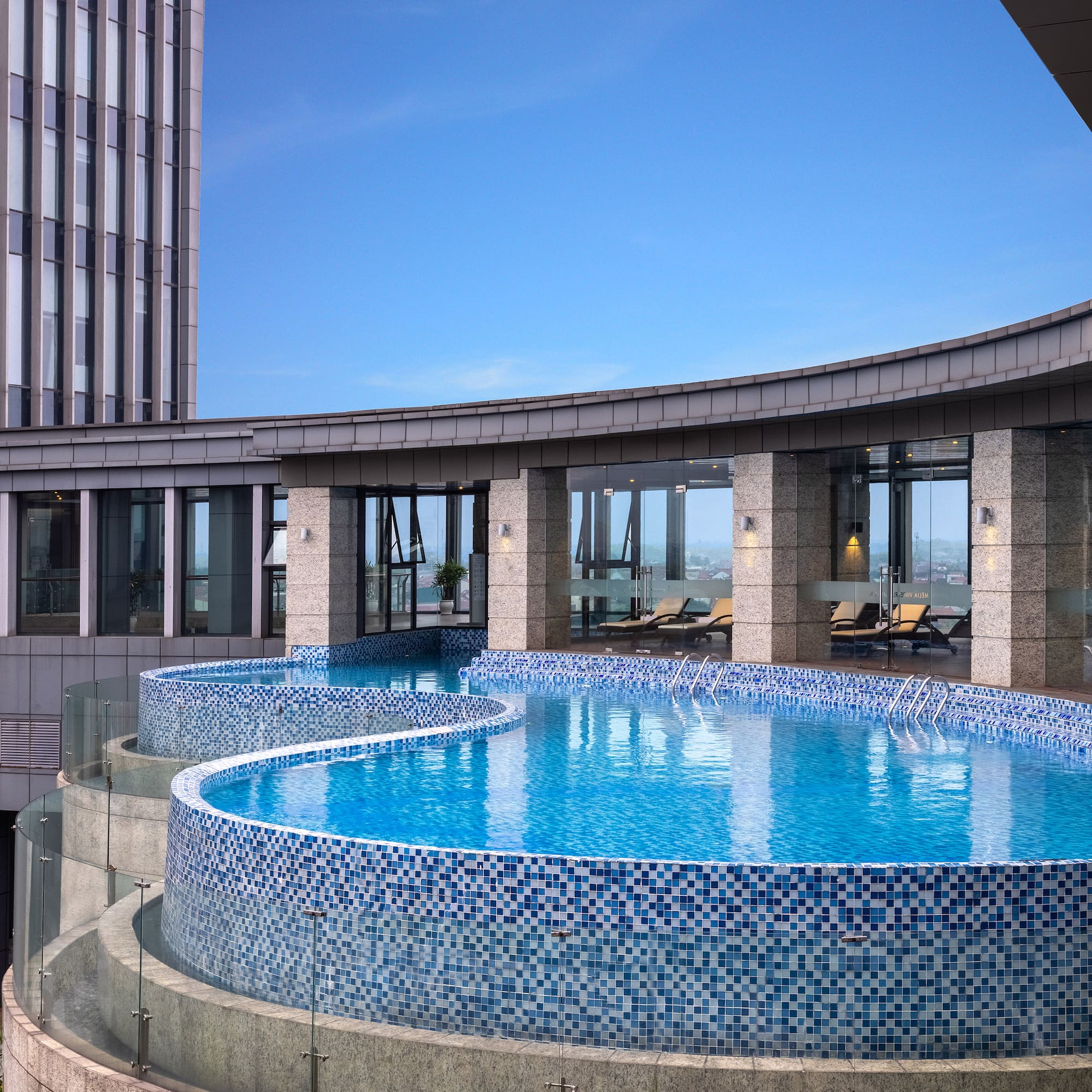 a pool with a circular pool in the middle of a building