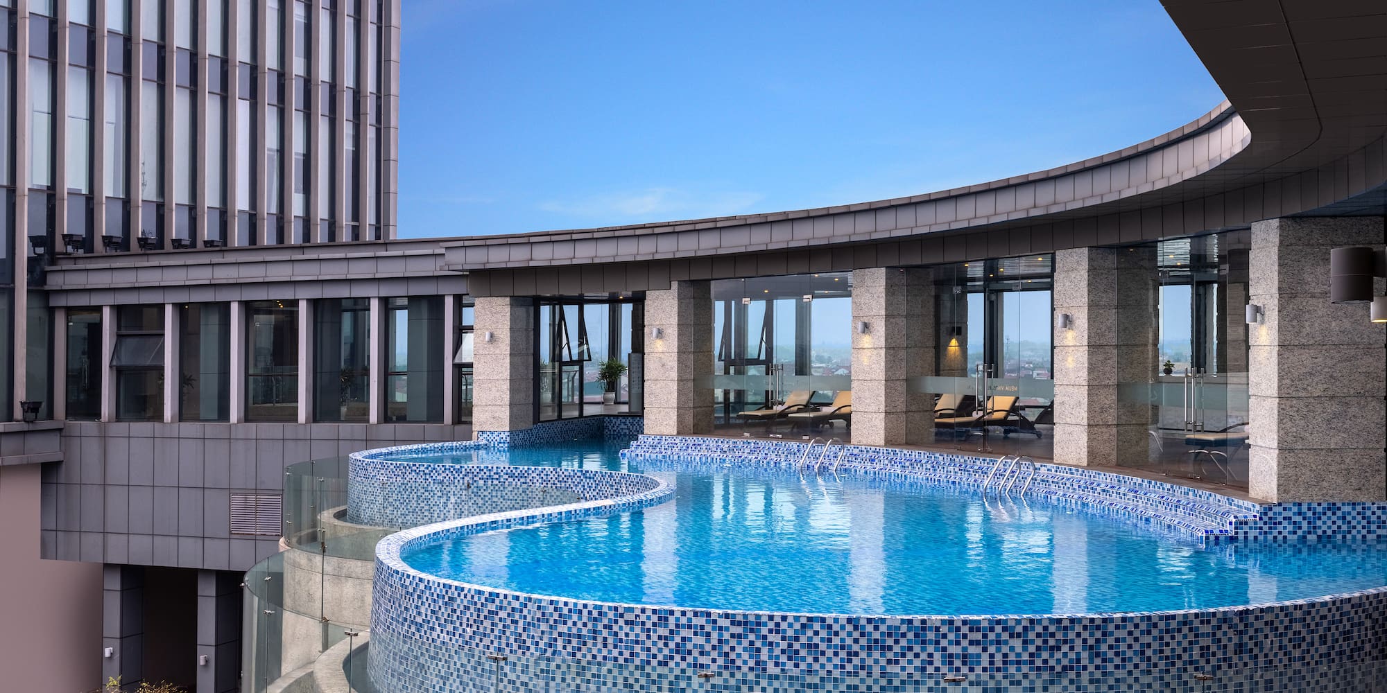 a pool with a circular pool in the middle of a building