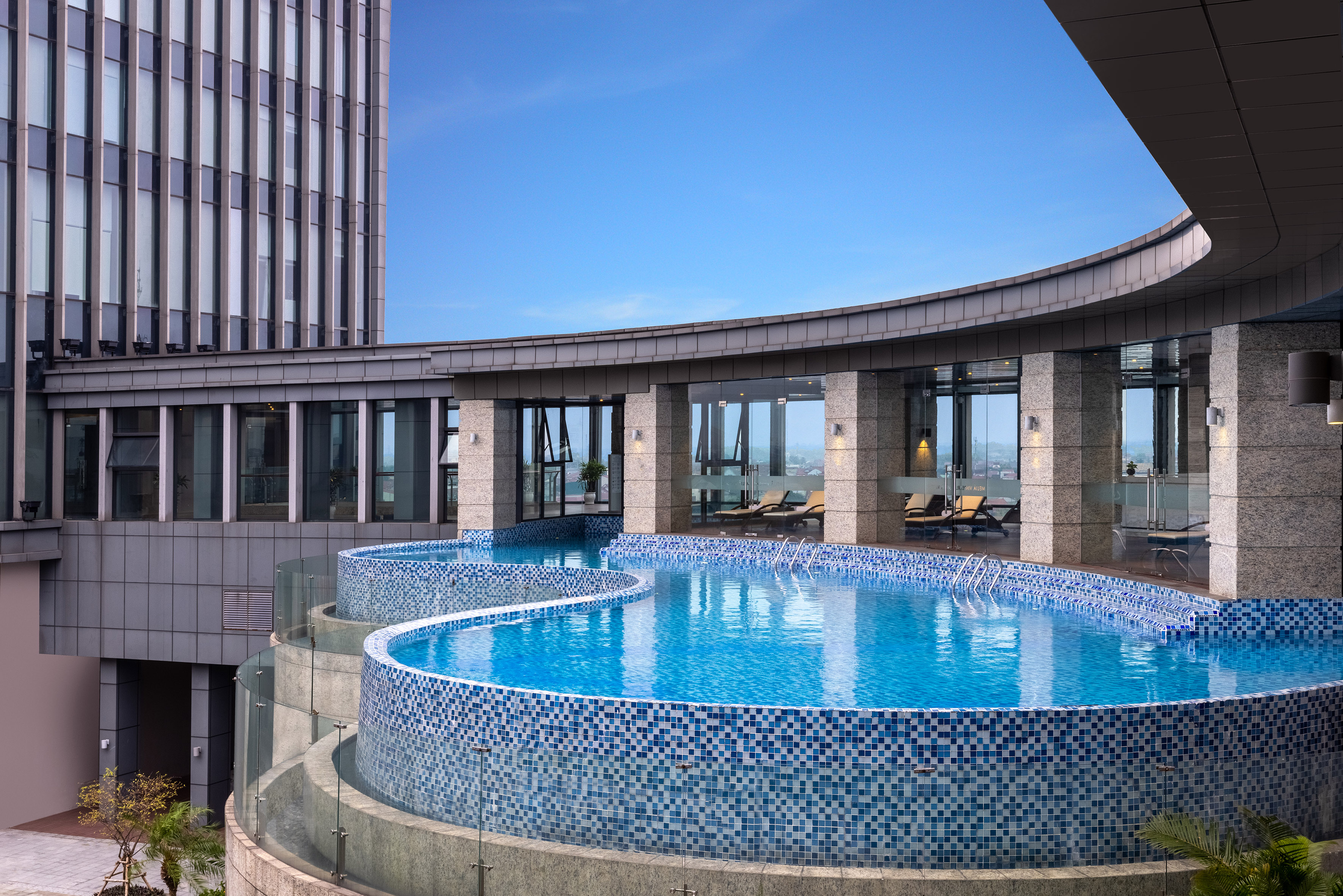 a pool with a circular pool in the middle of a building