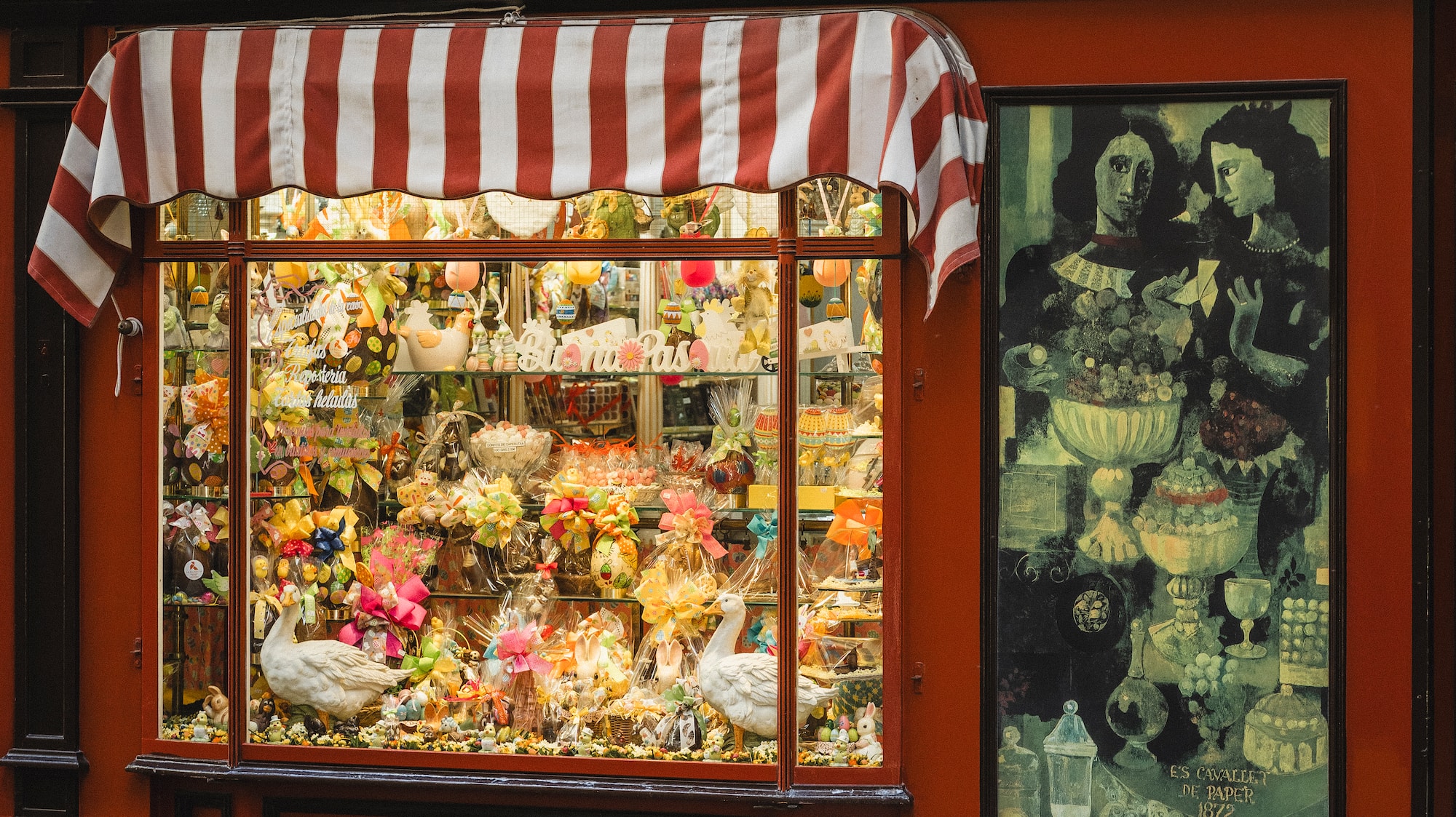a store front with flowers and birds