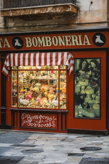 a store front with flowers and birds