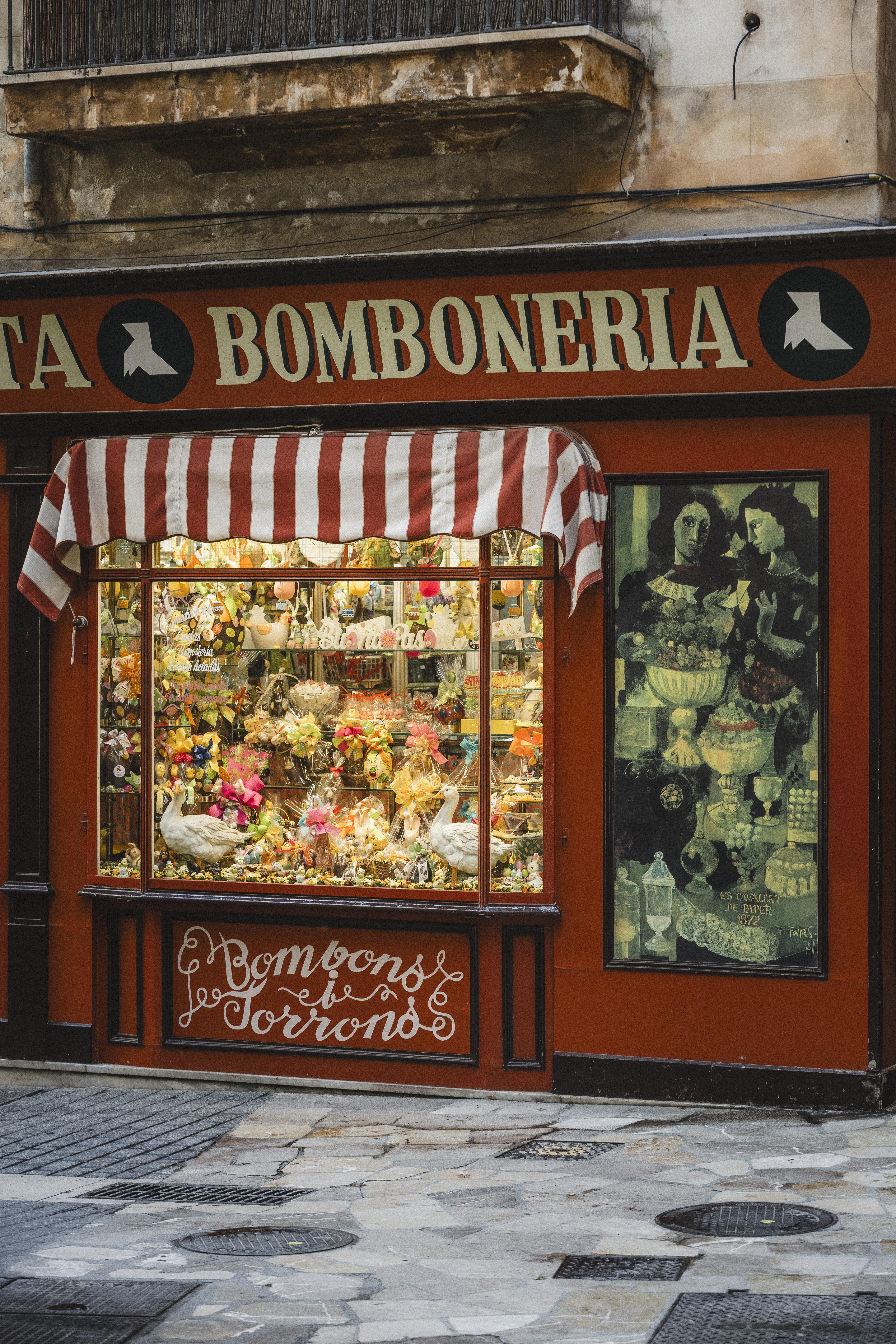 a store front with flowers and birds