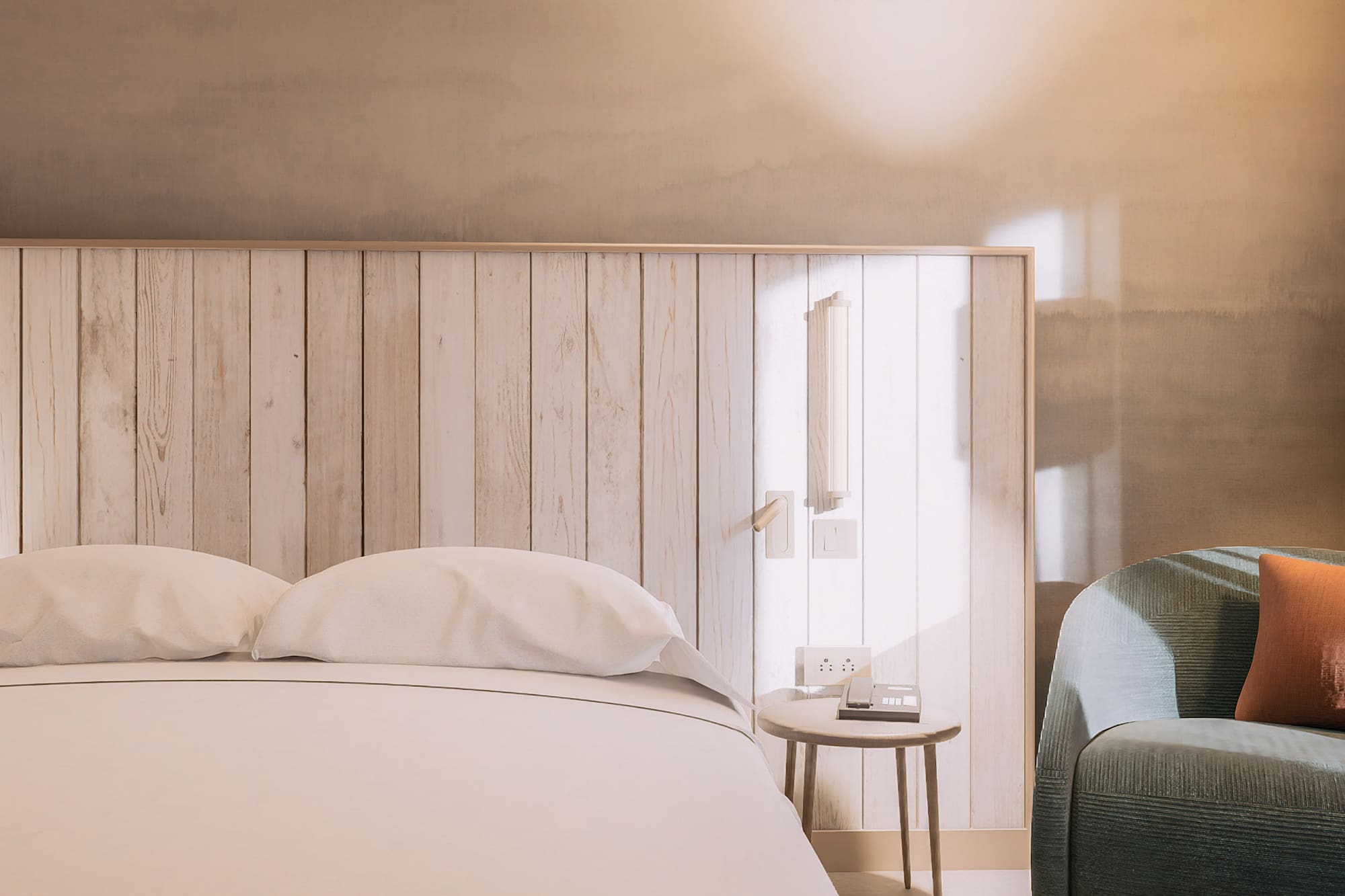 a bed with pillows and a table next to a bed