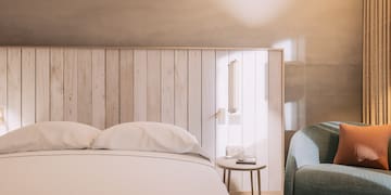 a bed with pillows and a table next to a bed