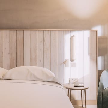 a bed with pillows and a table next to a bed