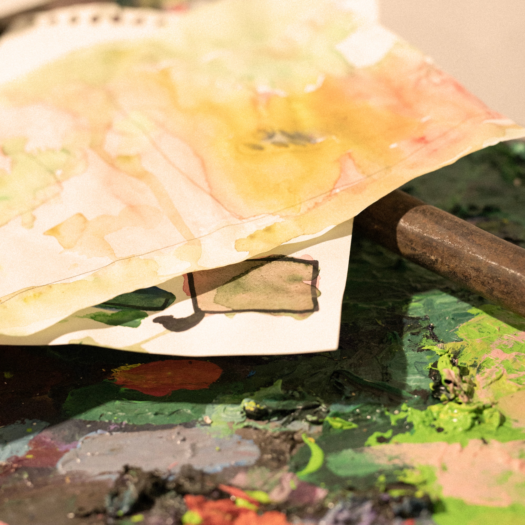 a paper bag with a metal rod on a paint palette