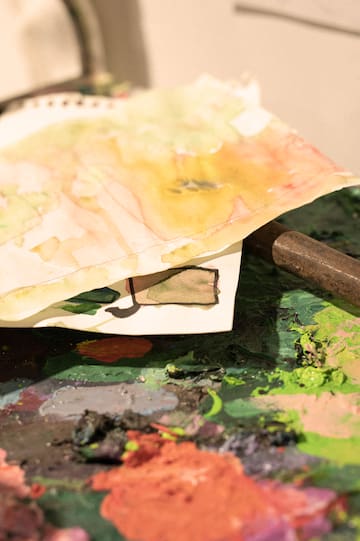 a paper bag with a metal rod on a paint palette