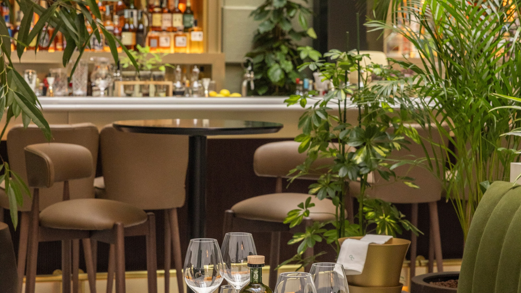 a table with wine glasses and bottles on it