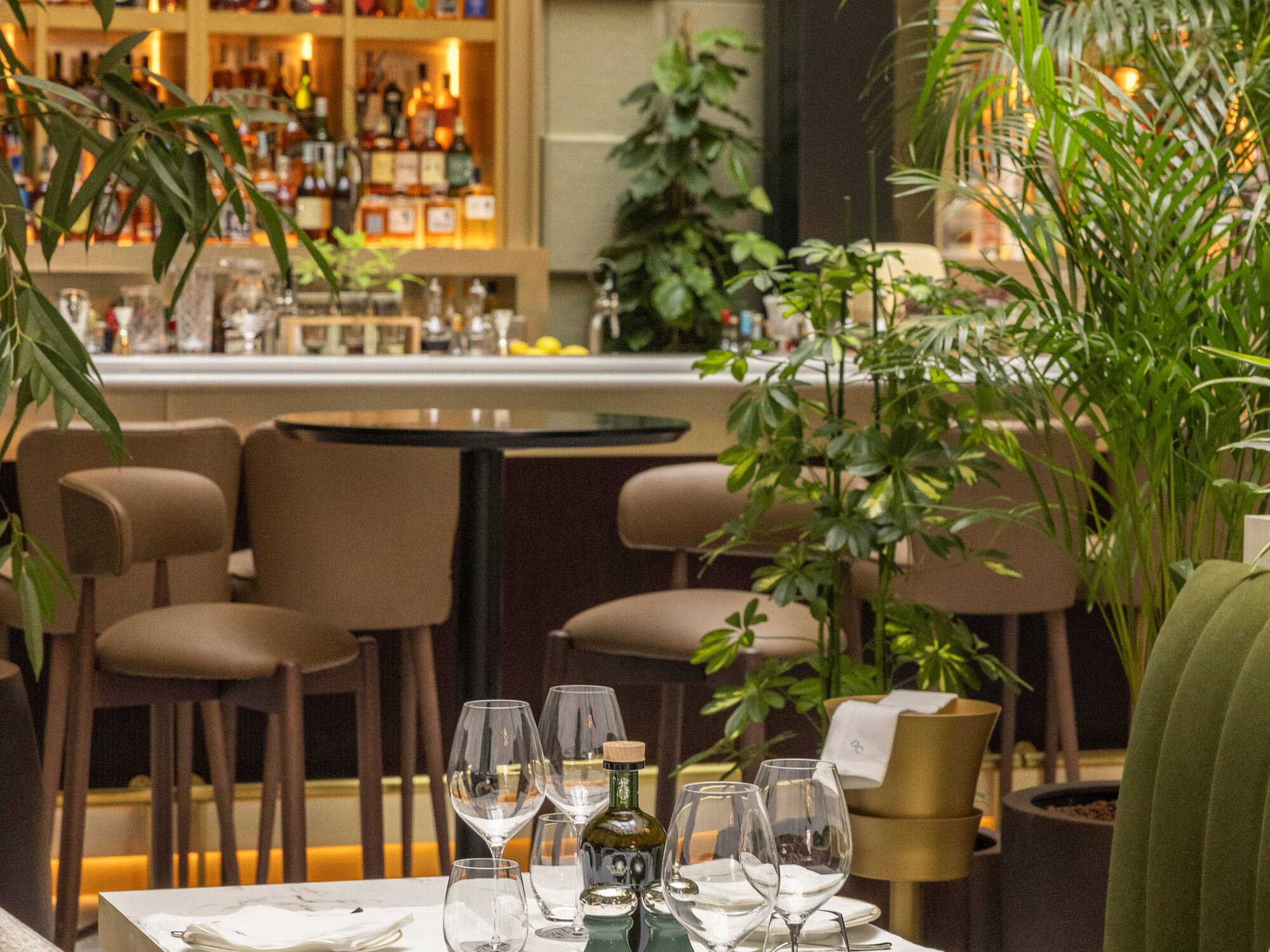 a table with wine glasses and bottles on it