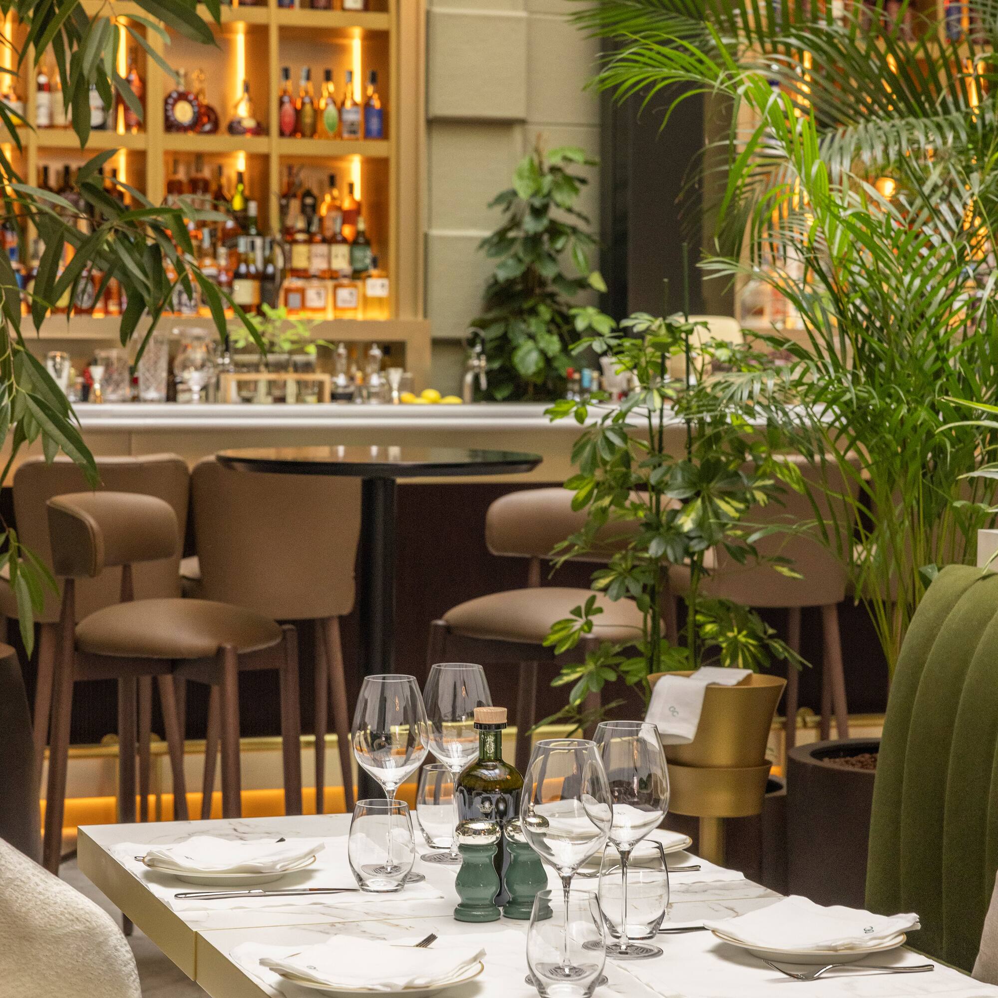 a table with wine glasses and bottles on it