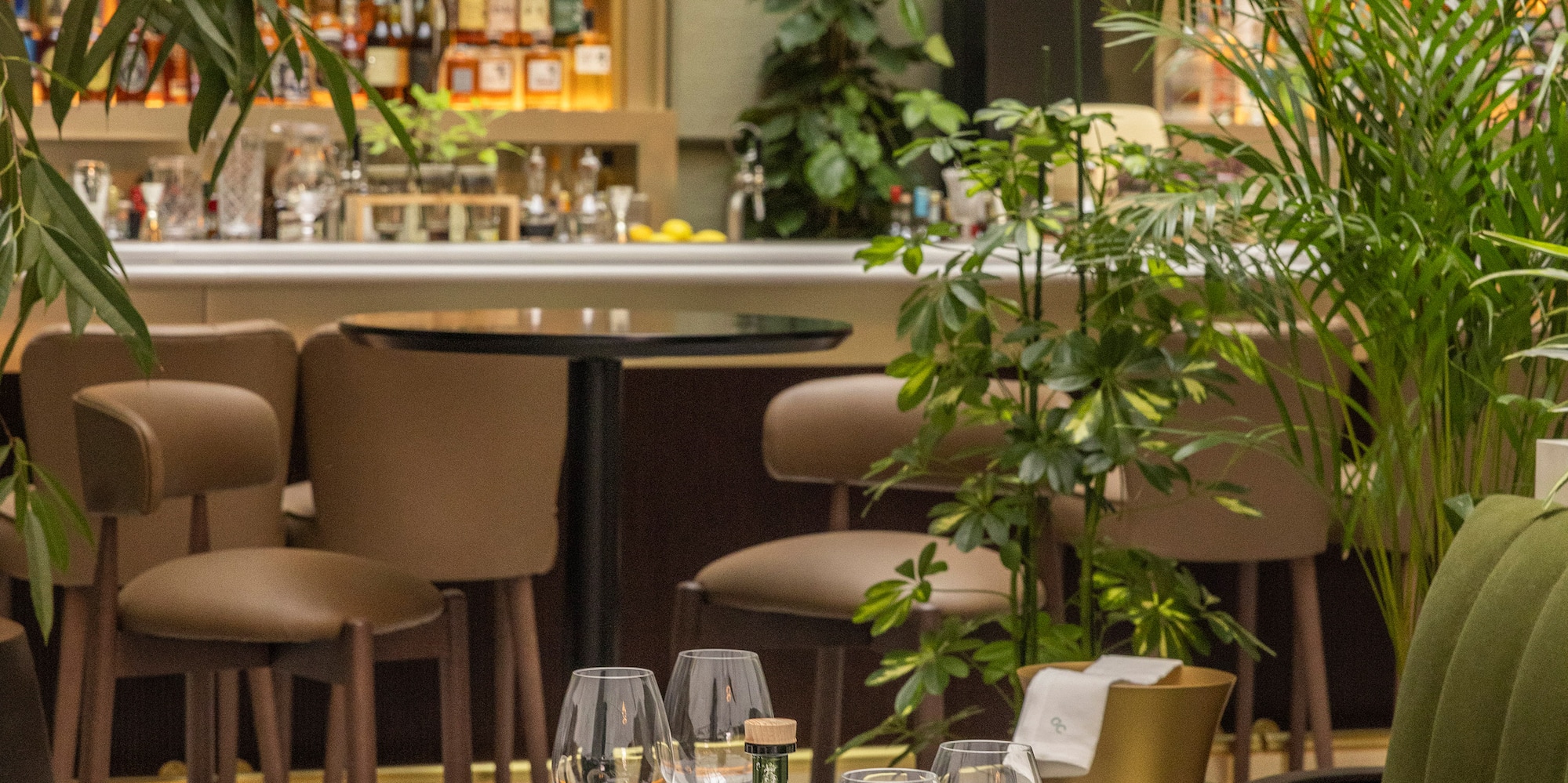 a table with wine glasses and bottles on it