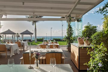 a restaurant with tables and chairs and plants