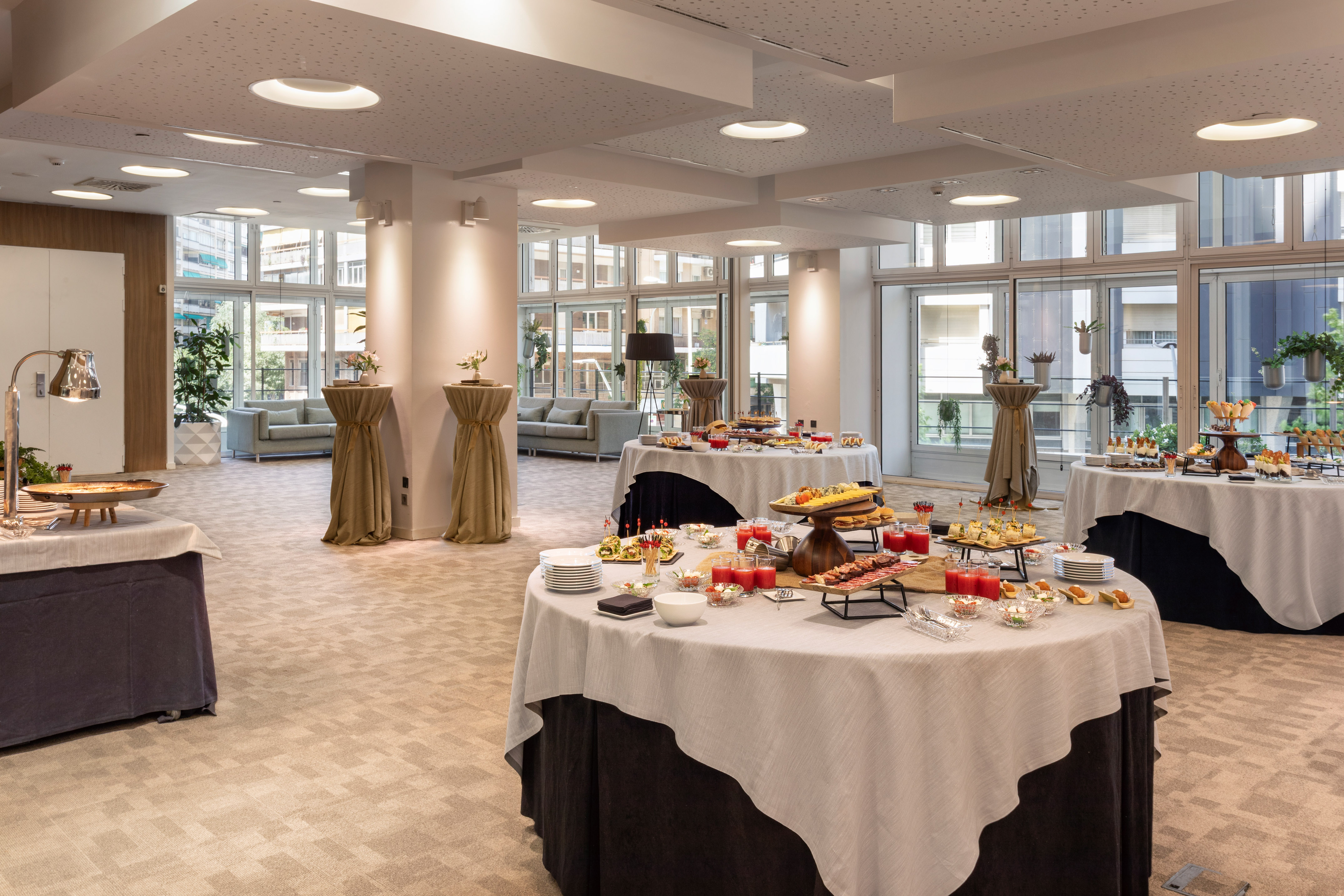 Hotel lobby event space with buffet tables and modern decor.
