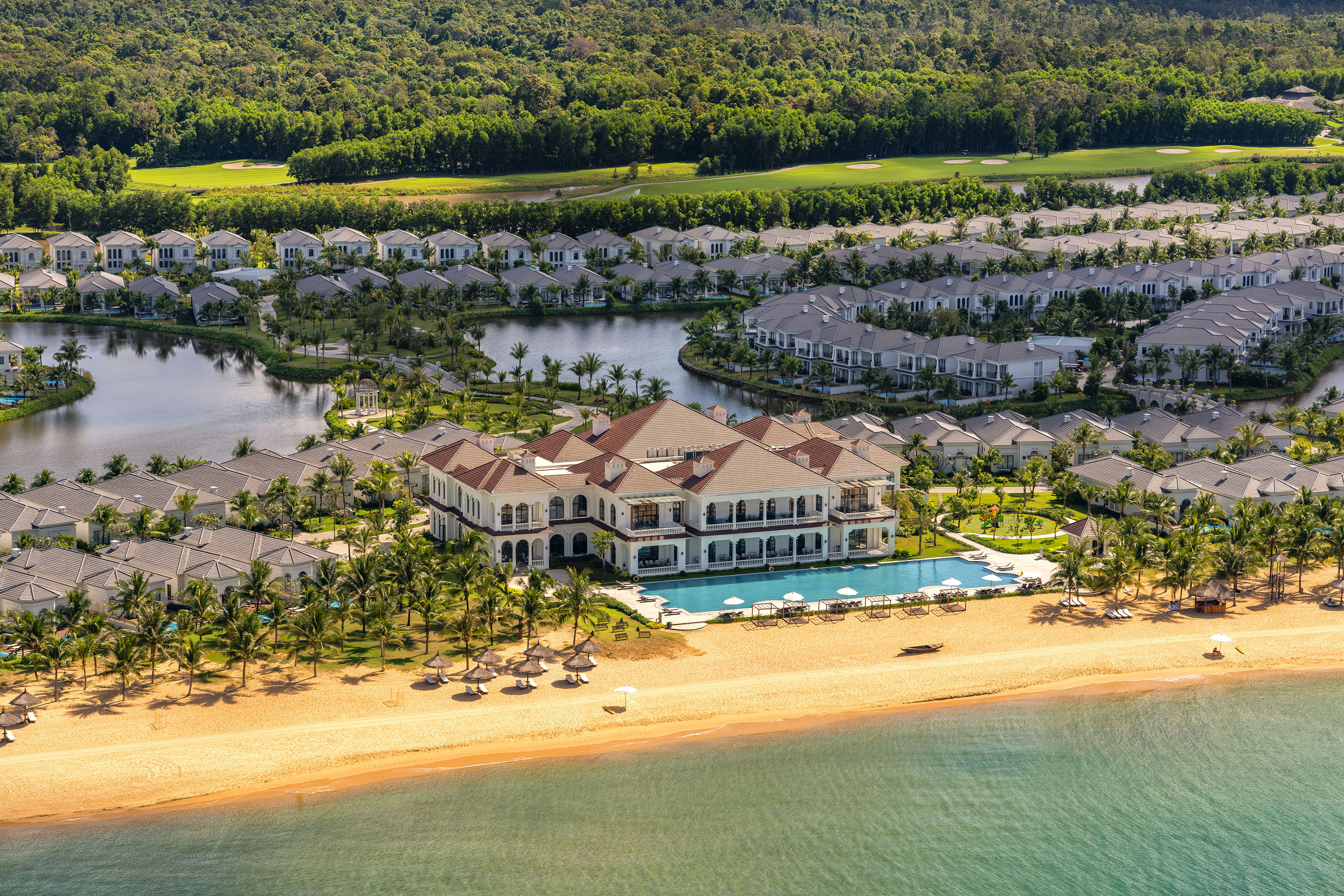 a large resort with a pool and a beach