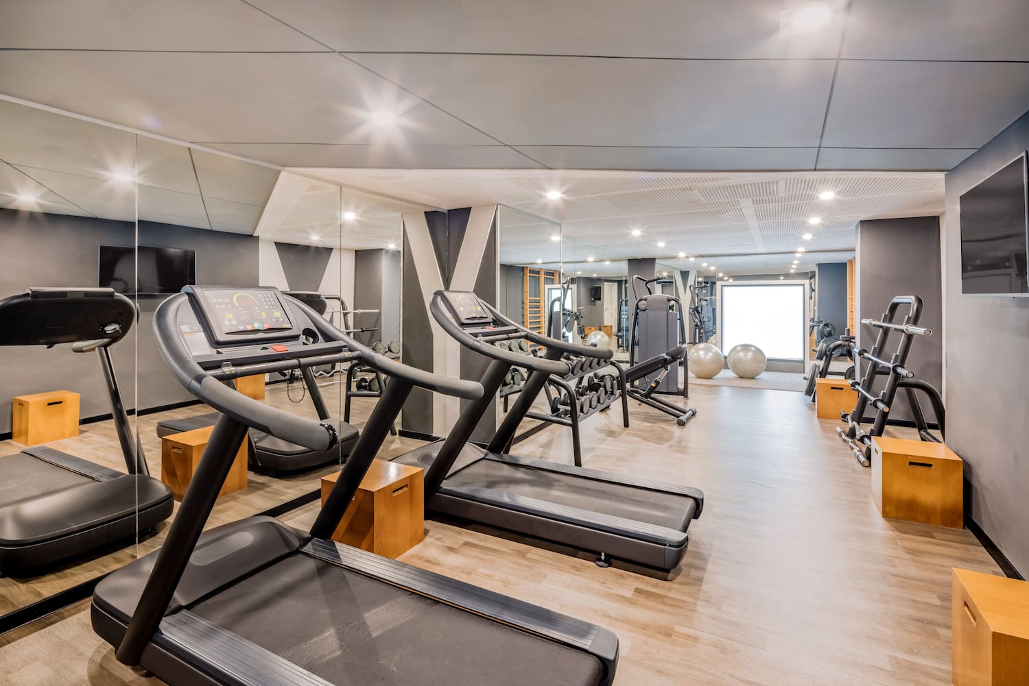 a room with treadmills and exercise balls