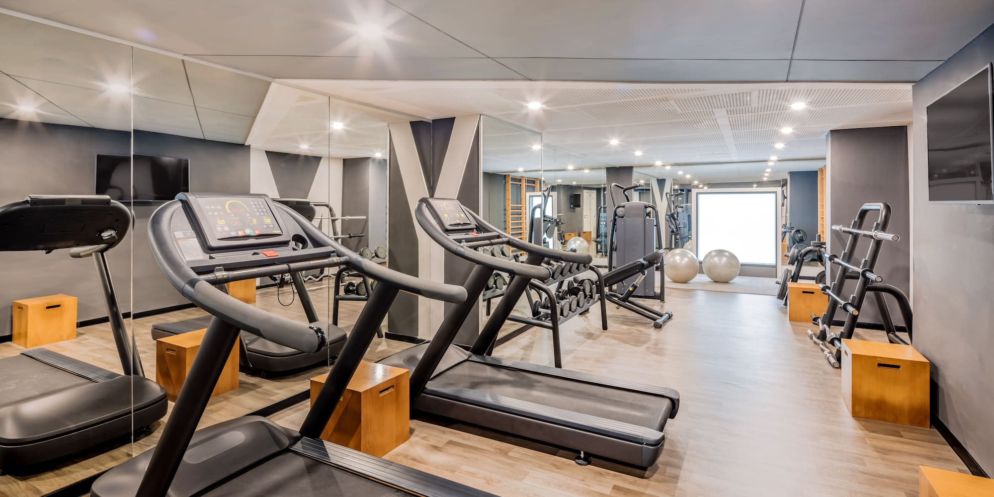 a room with treadmills and exercise balls