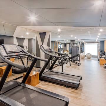 a room with treadmills and exercise balls