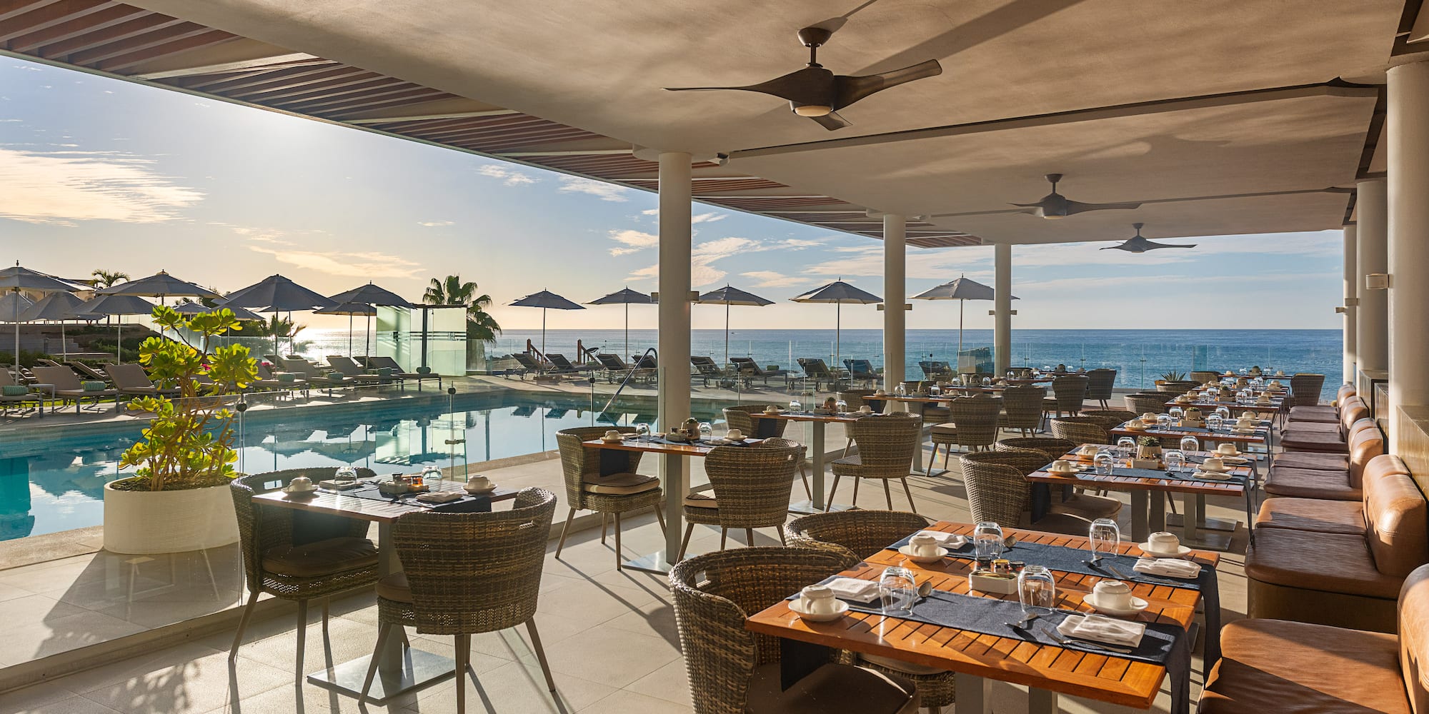a restaurant with tables and chairs and a pool