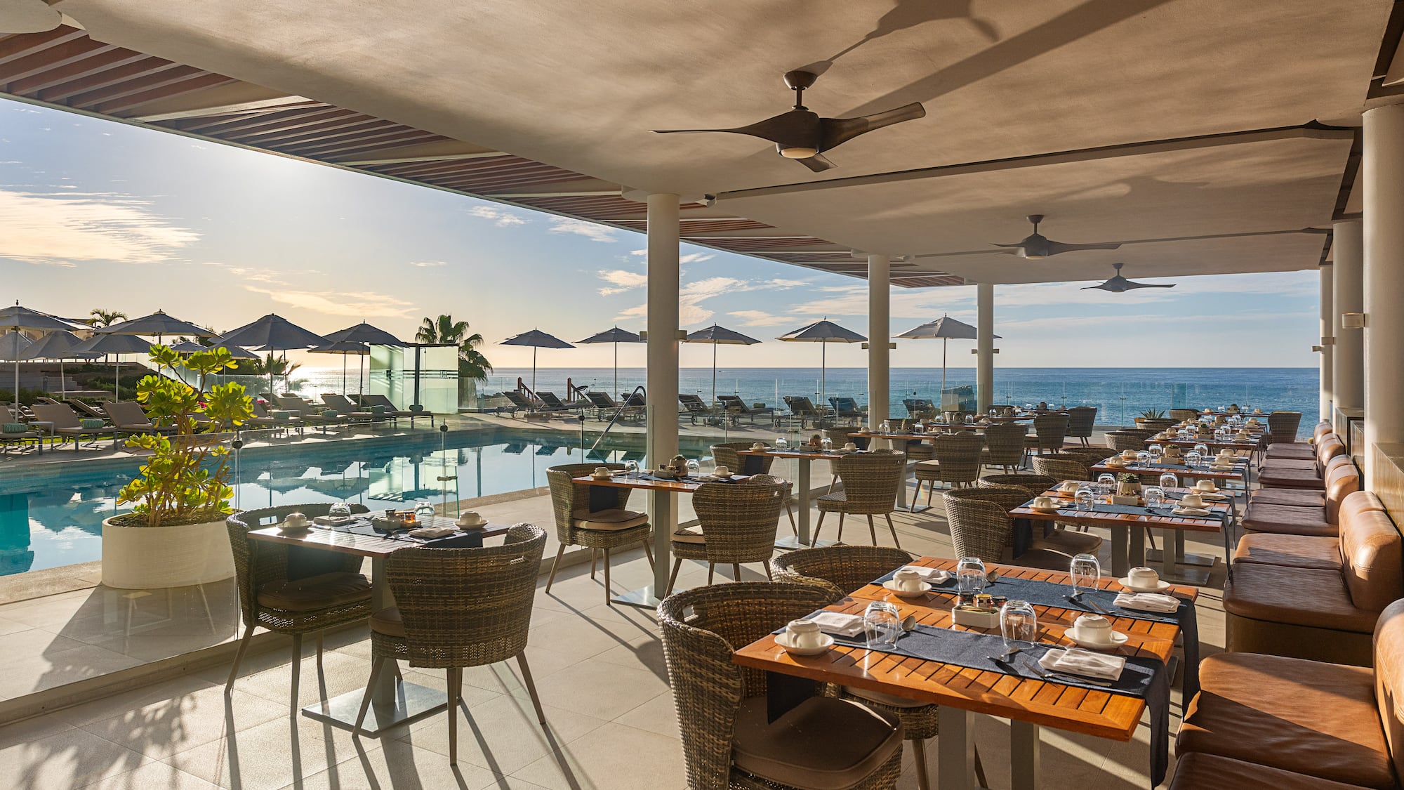 a restaurant with tables and chairs and a pool