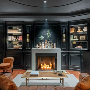 a room with black walls and a fireplace