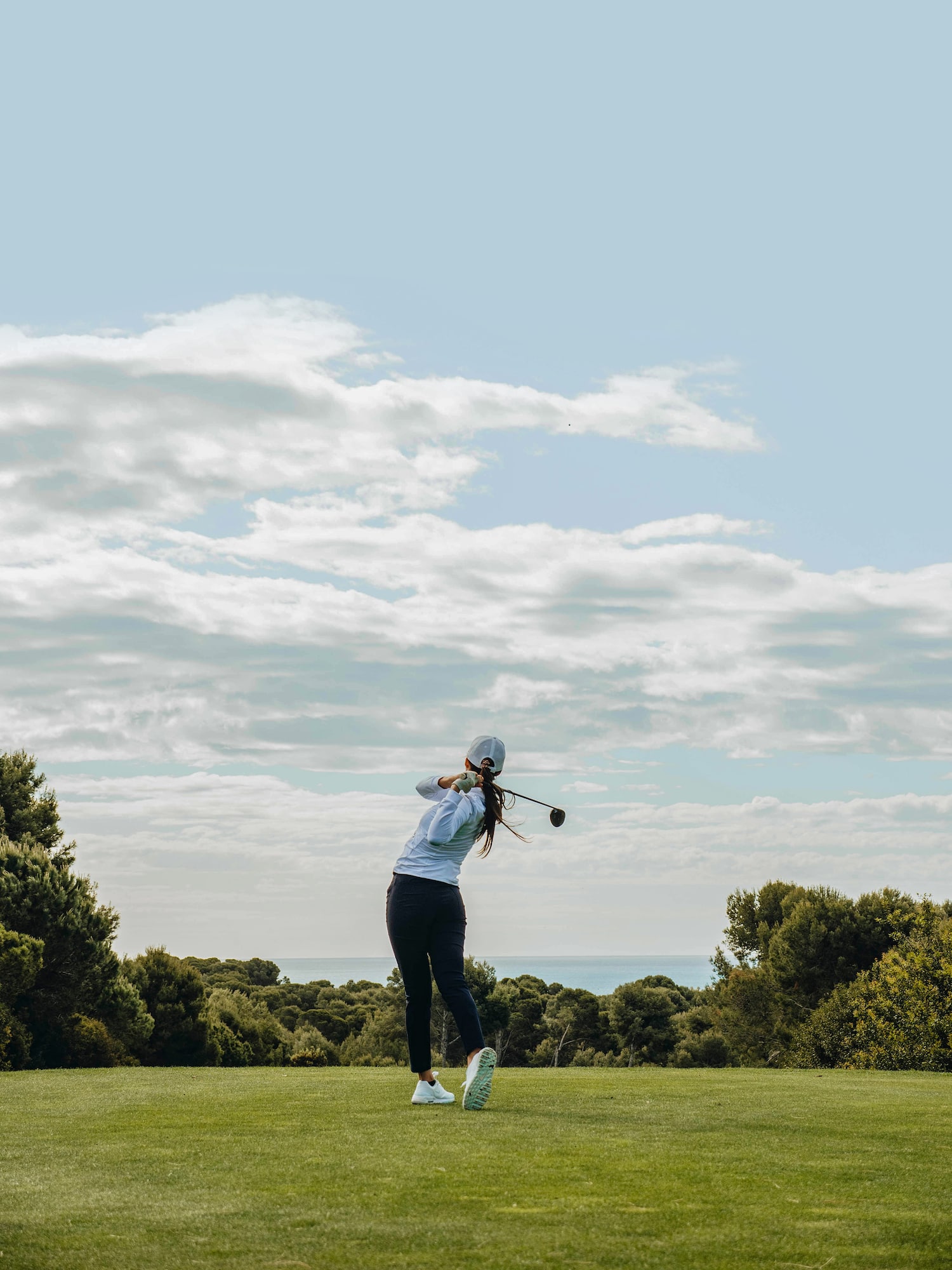 a person swinging a golf club