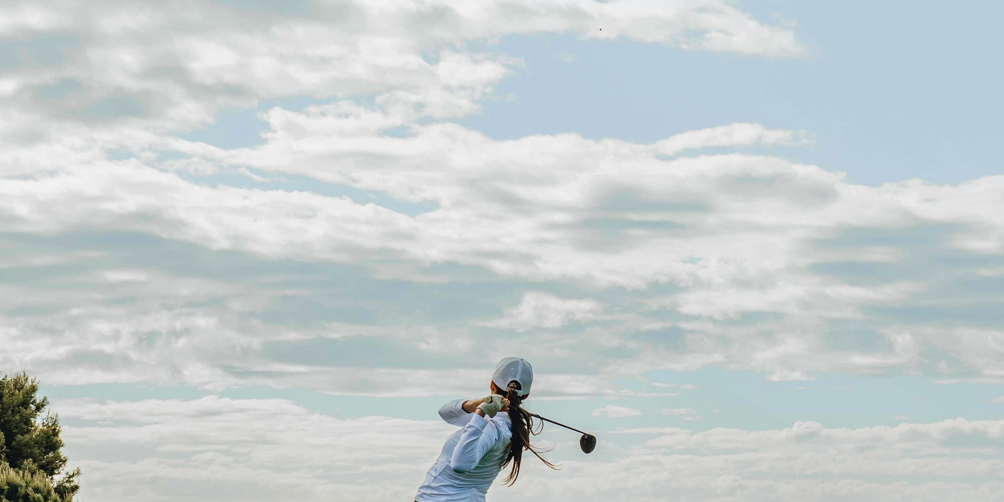 a person swinging a golf club