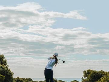 a person swinging a golf club