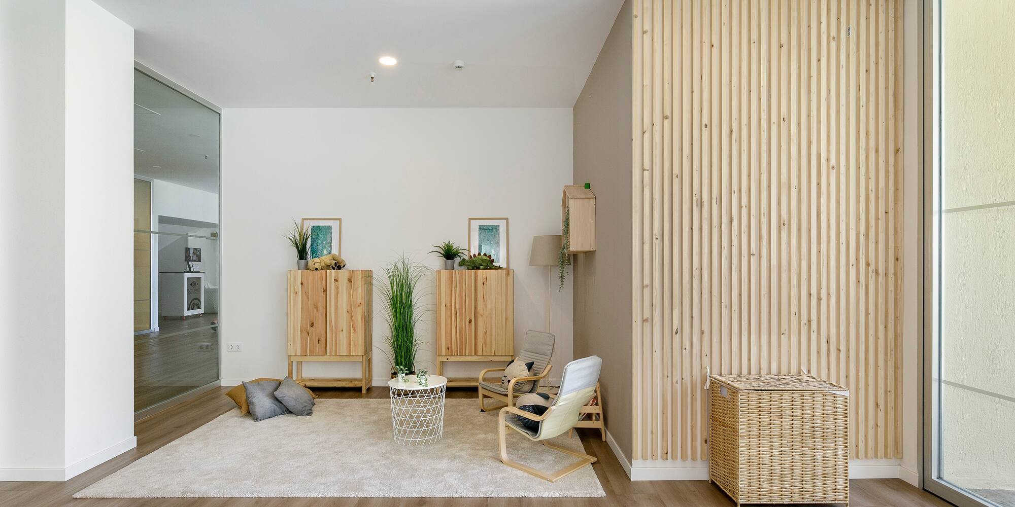 a room with a wood wall and a white rug