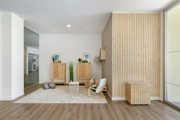 a room with a wood wall and a white rug
