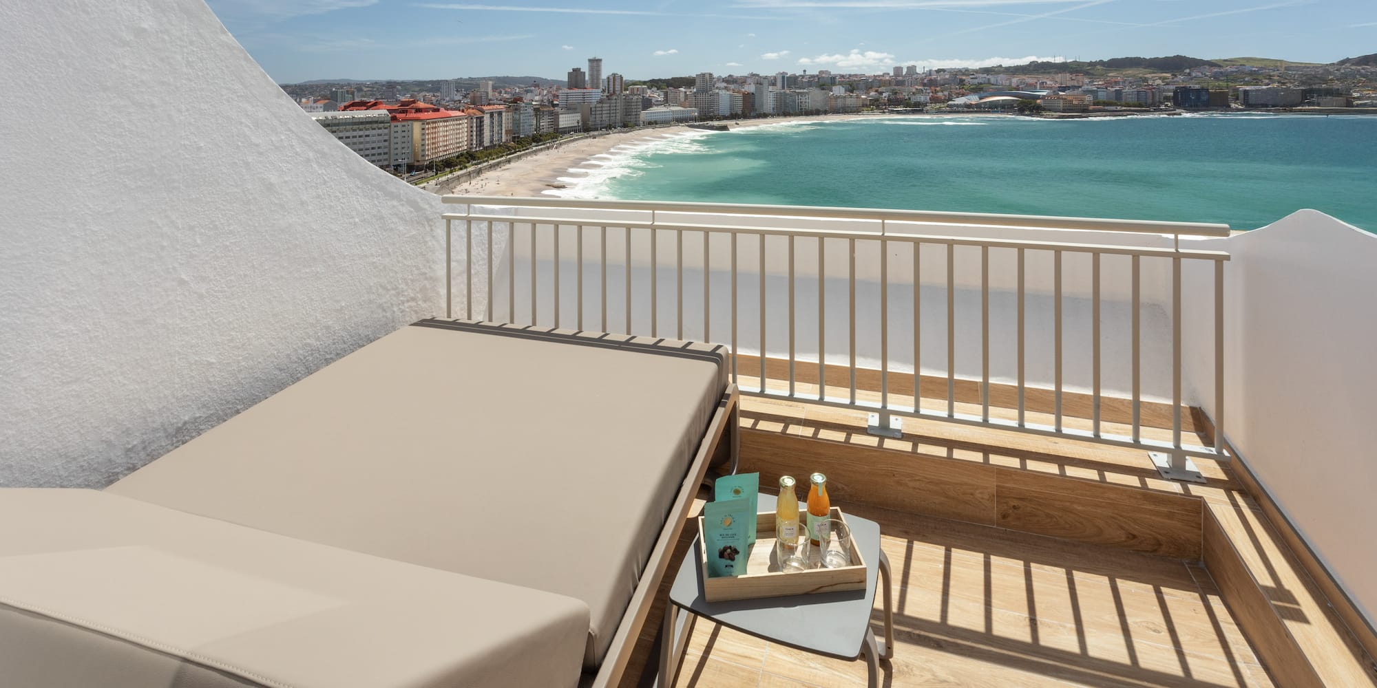 a balcony with a view of the beach and a city