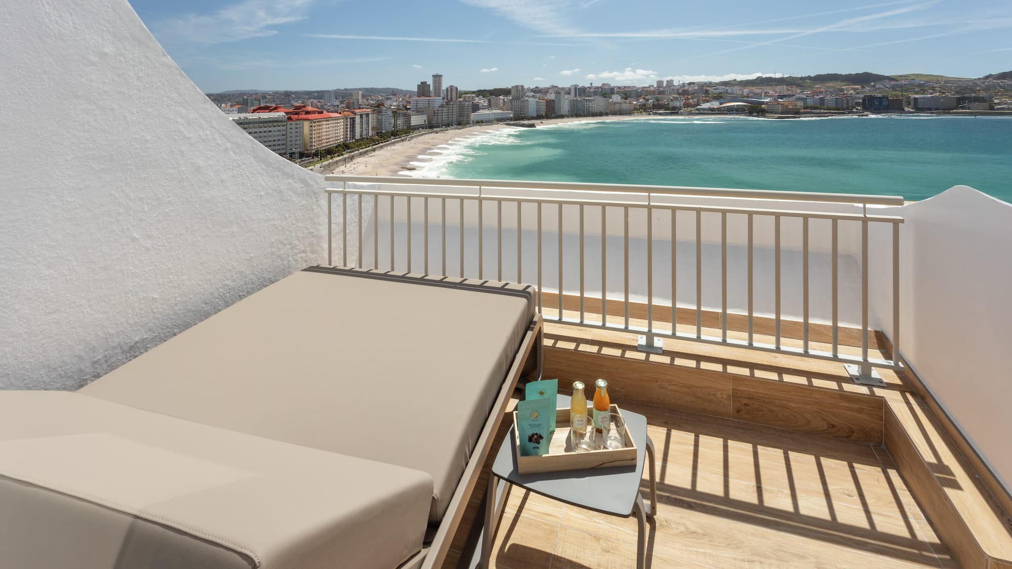 a balcony with a view of the beach and a city