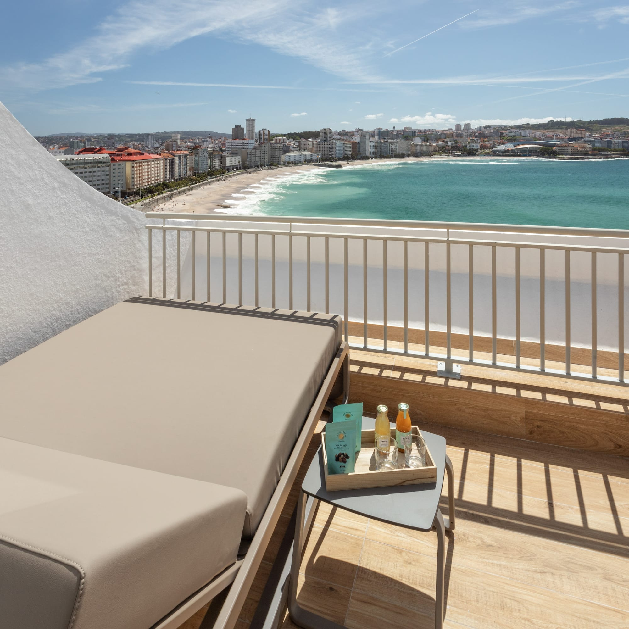 a balcony with a view of the beach and a city