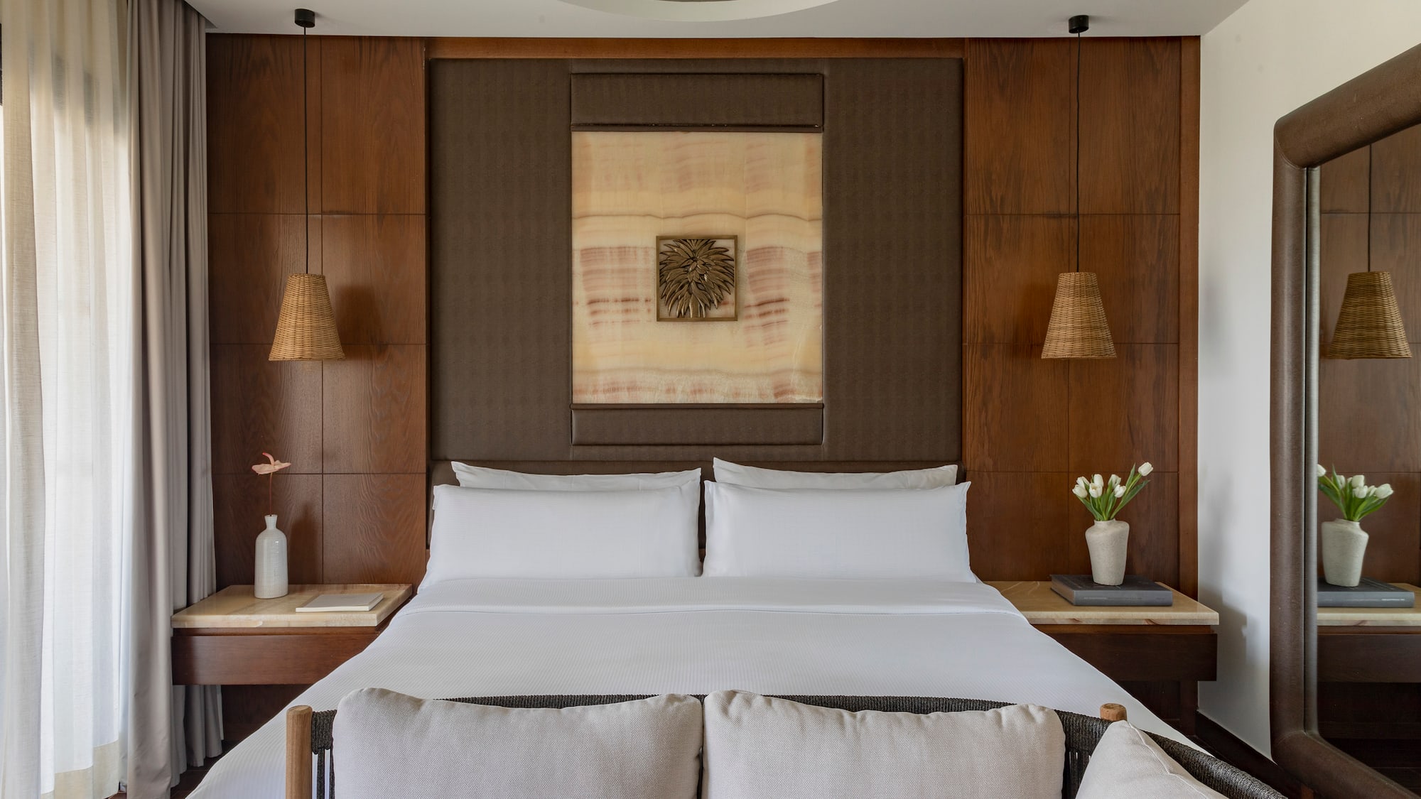 a bed with white sheets and pillows in a room