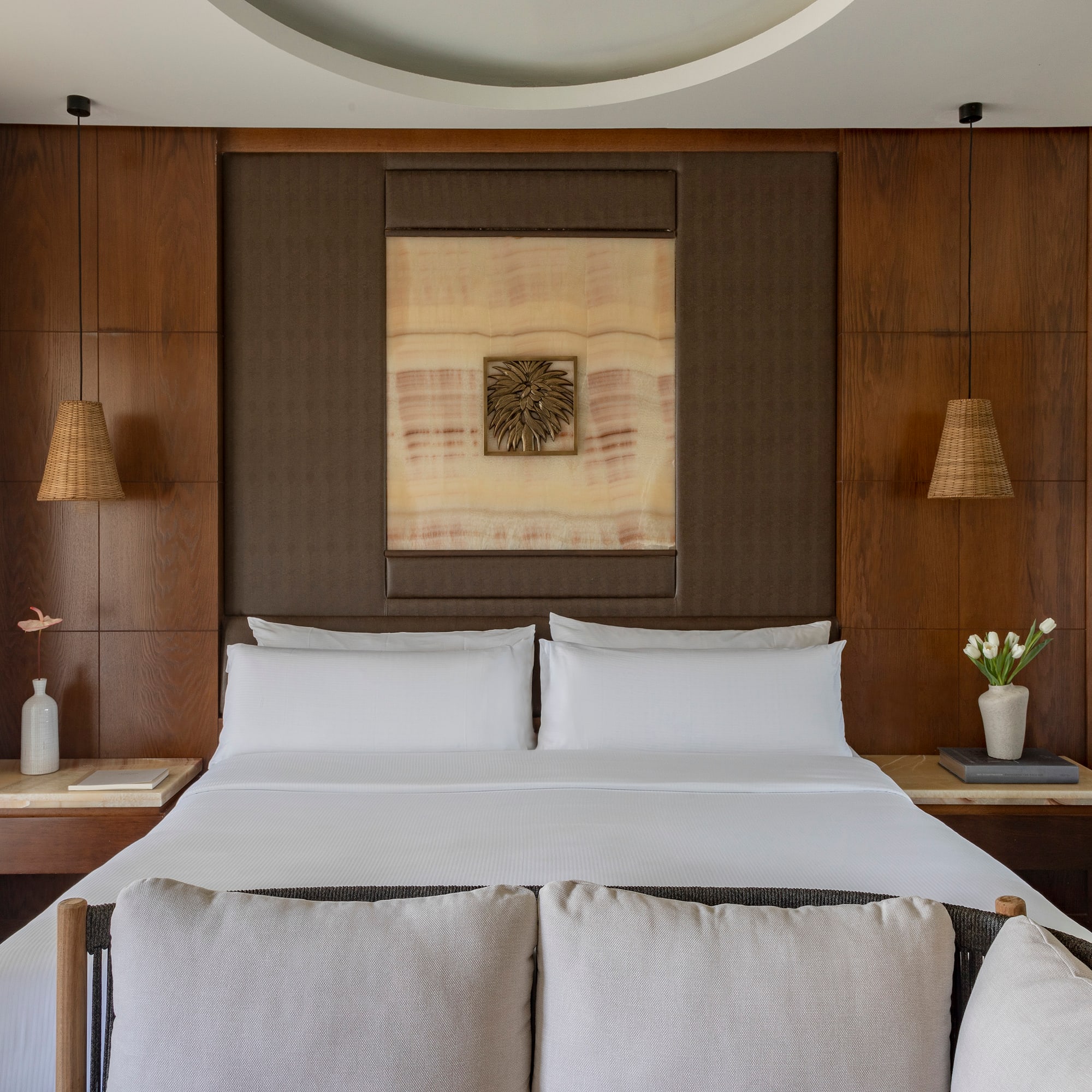 a bed with white sheets and pillows in a room