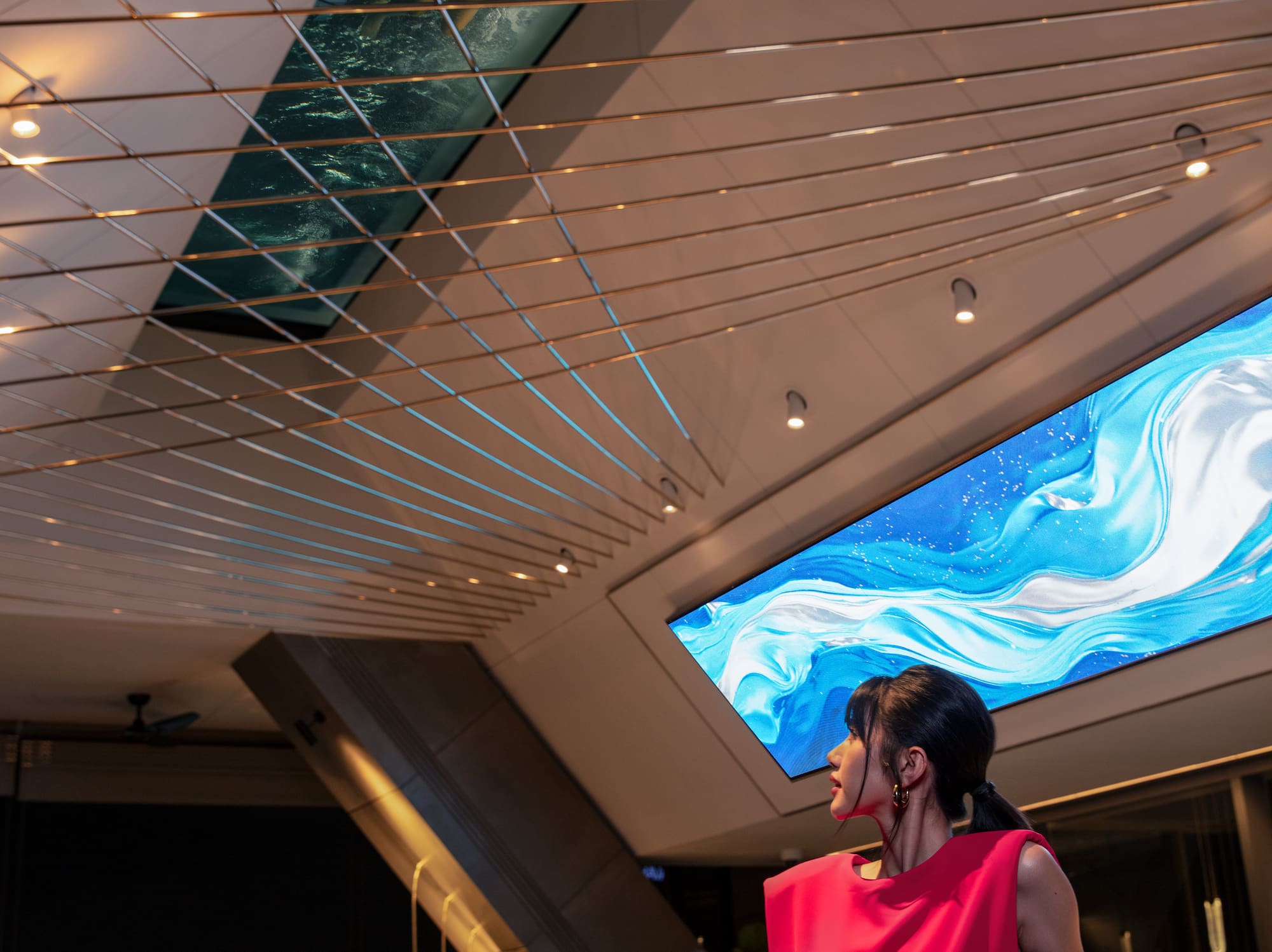 a woman in a red dress standing at a bar