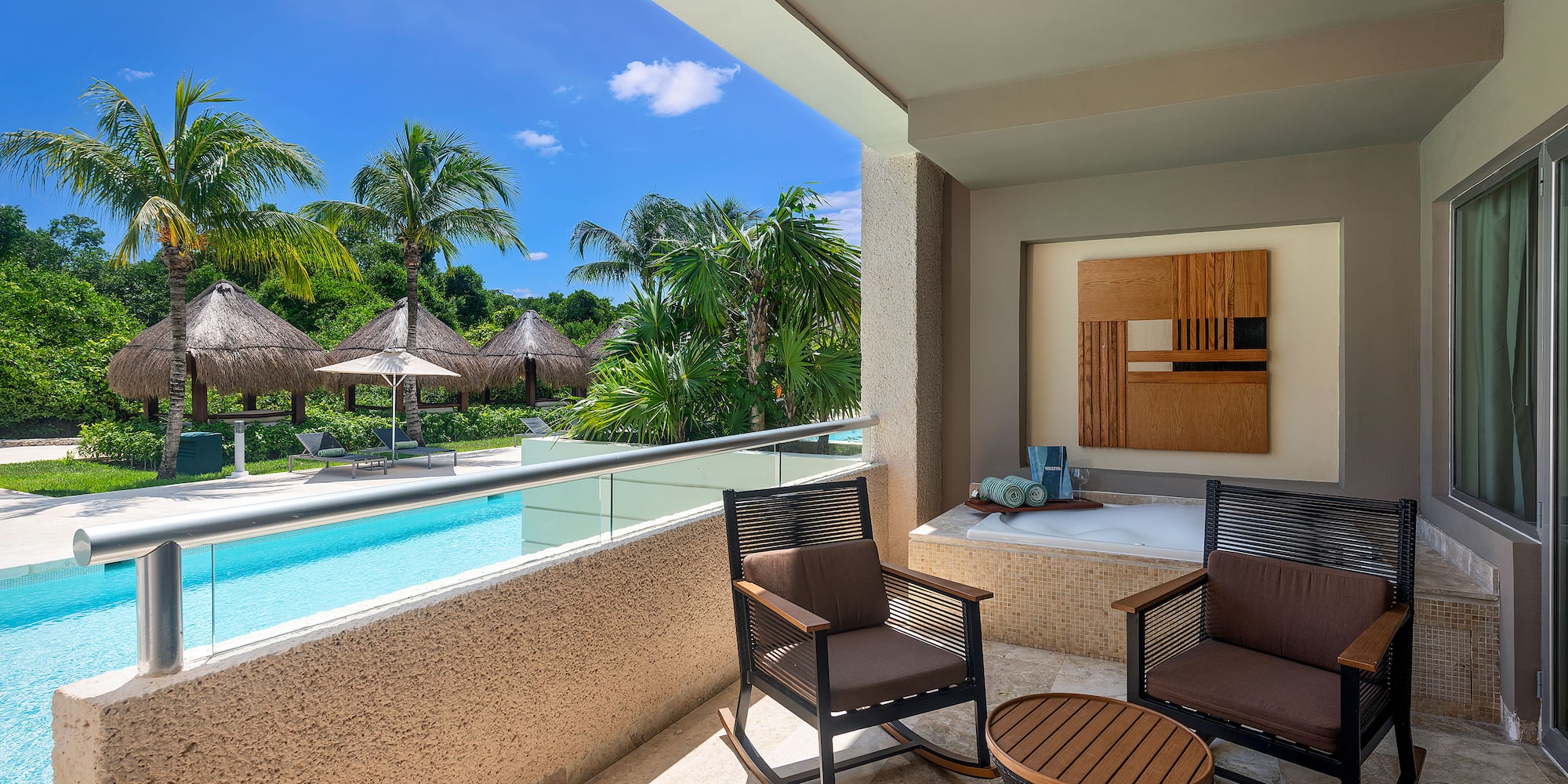 a patio with chairs and a jacuzzi.