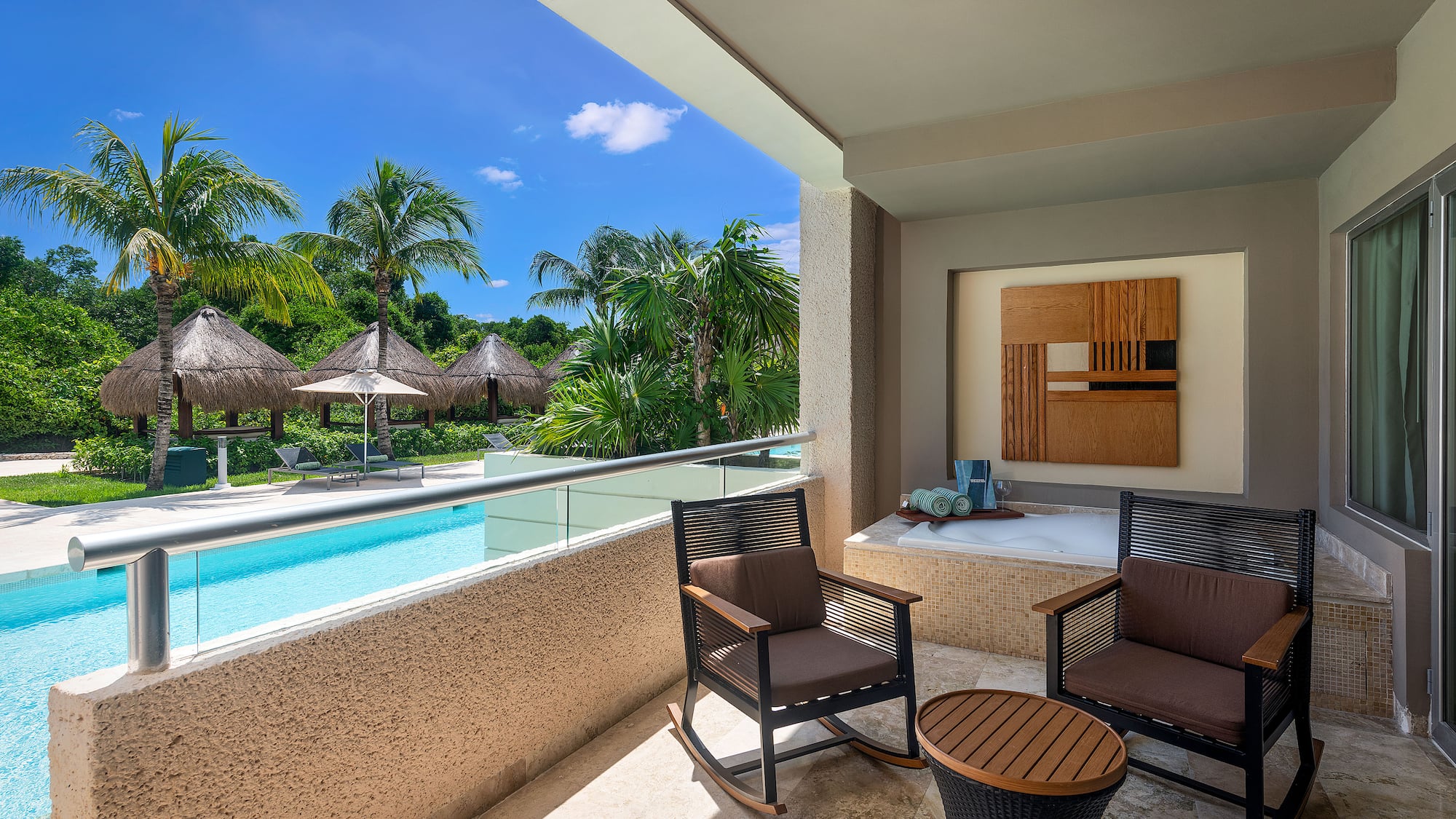 a patio with chairs and a jacuzzi.
