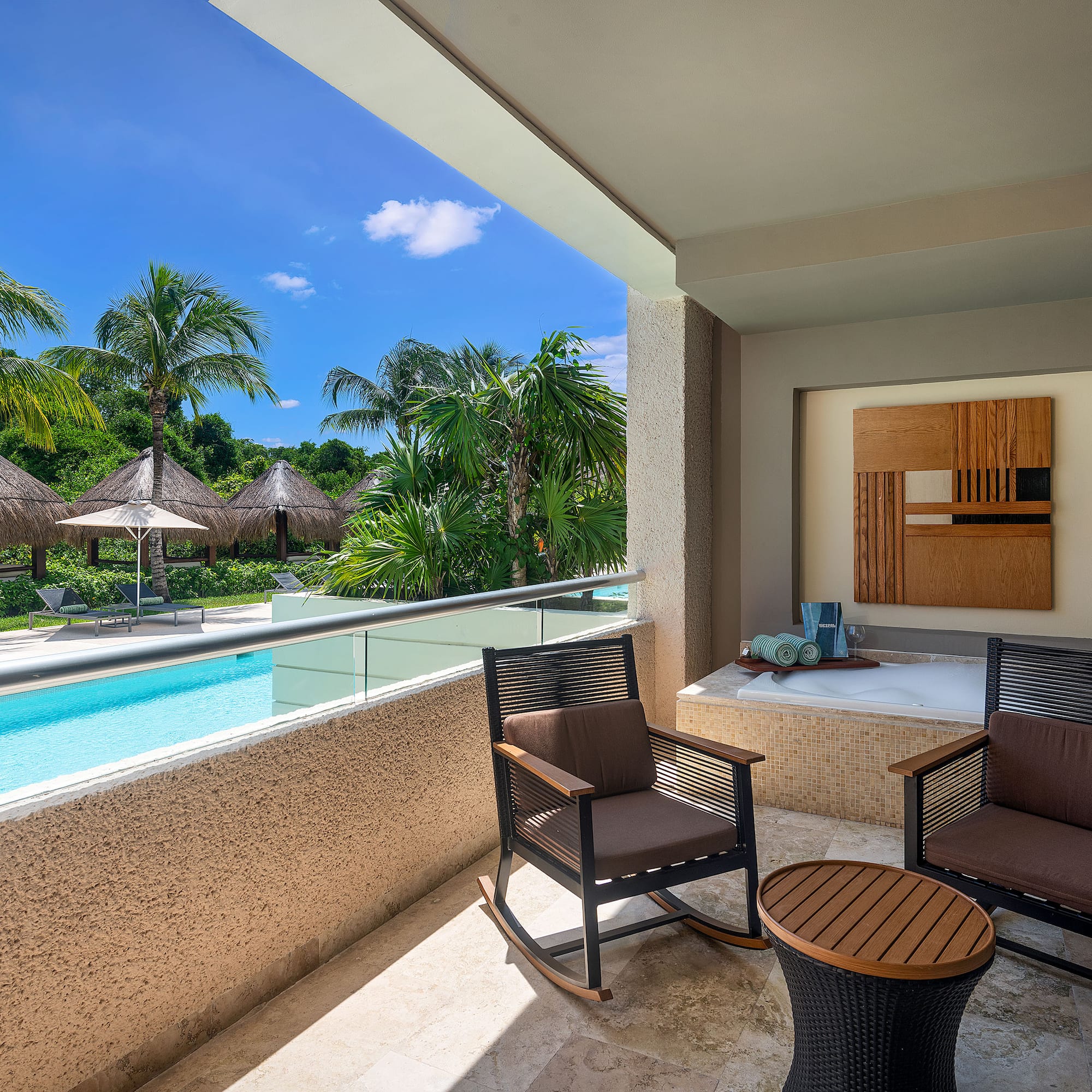 a patio with chairs and a jacuzzi.