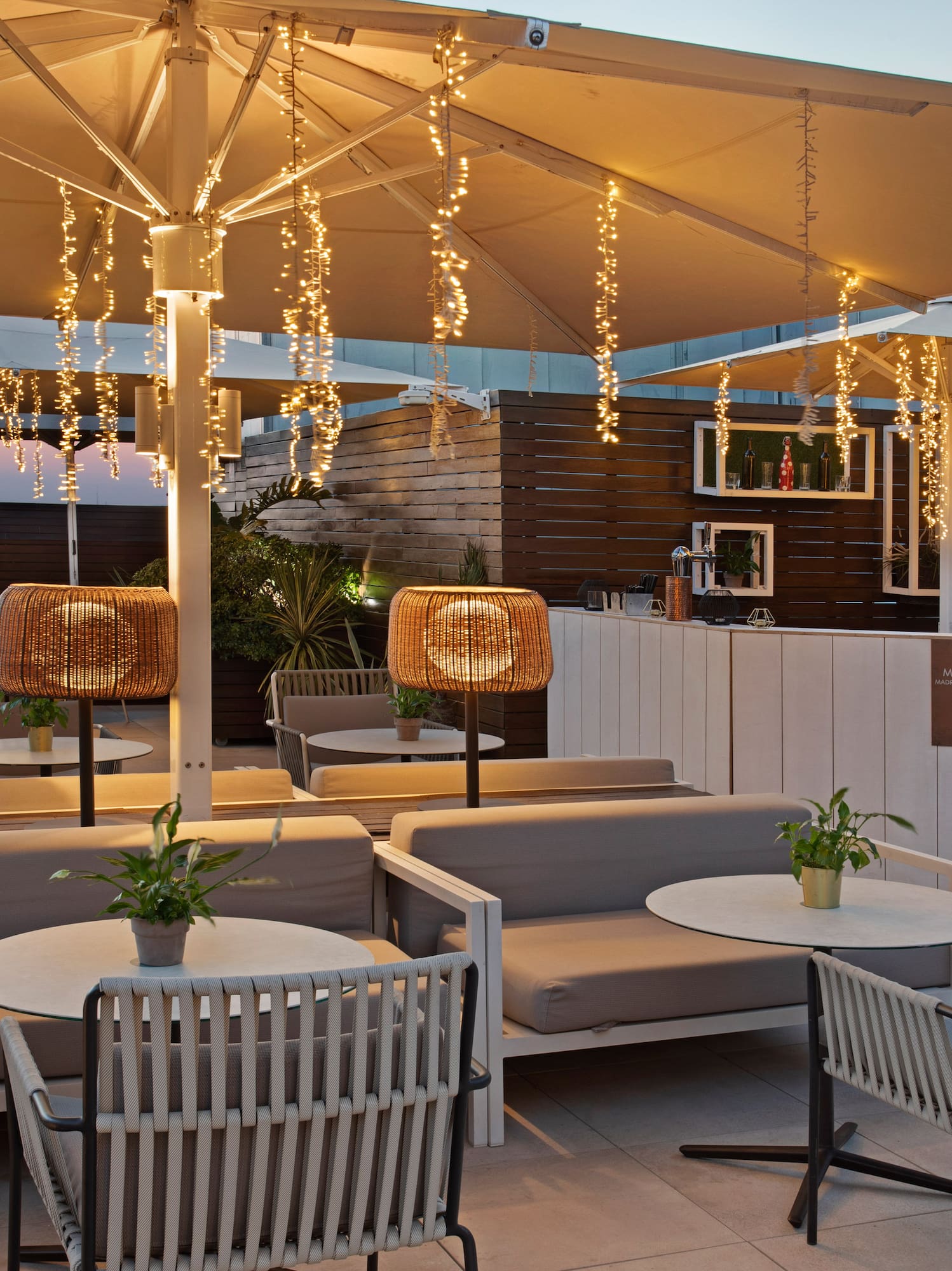 a patio with tables and chairs and lights