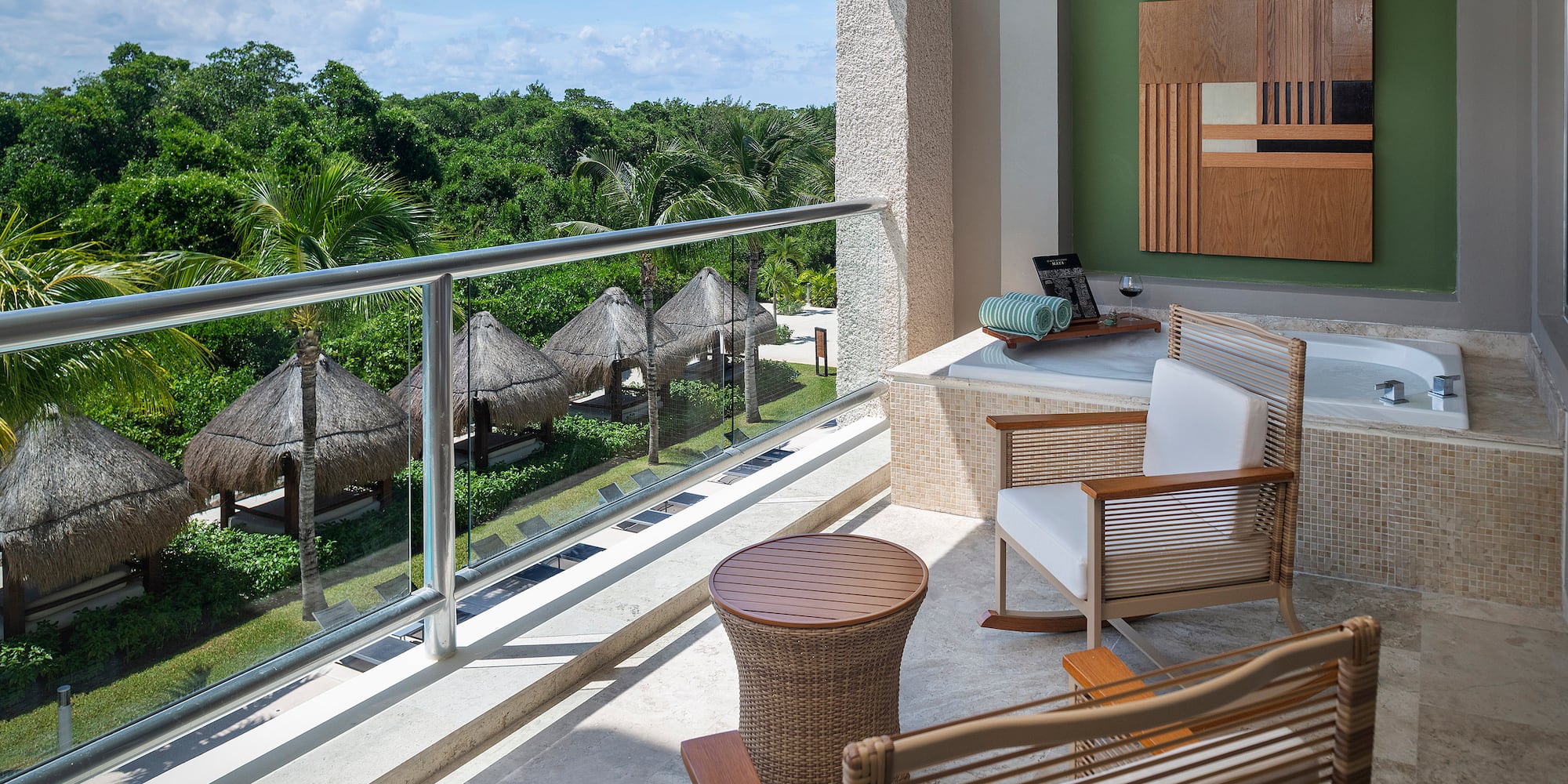 a balcony with chairs and a table.