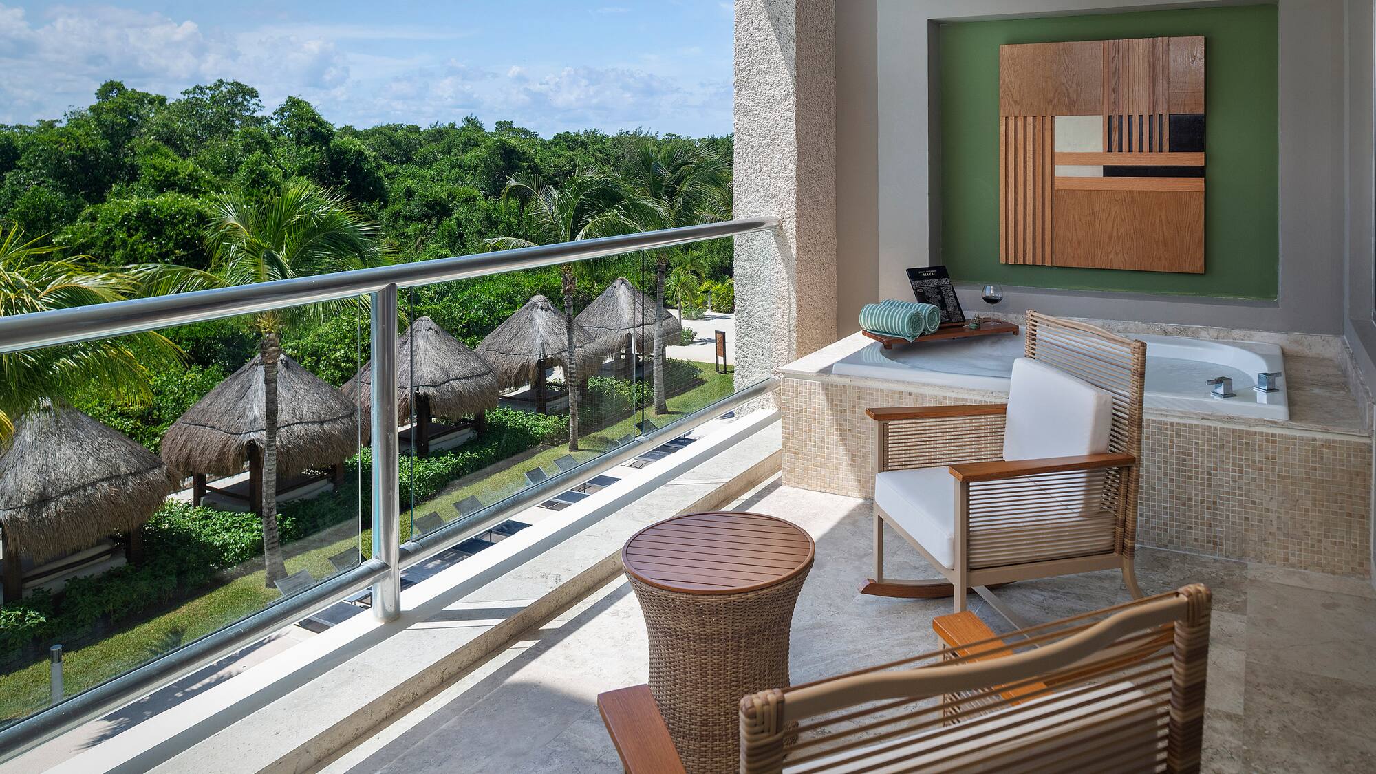 a balcony with chairs and a table.