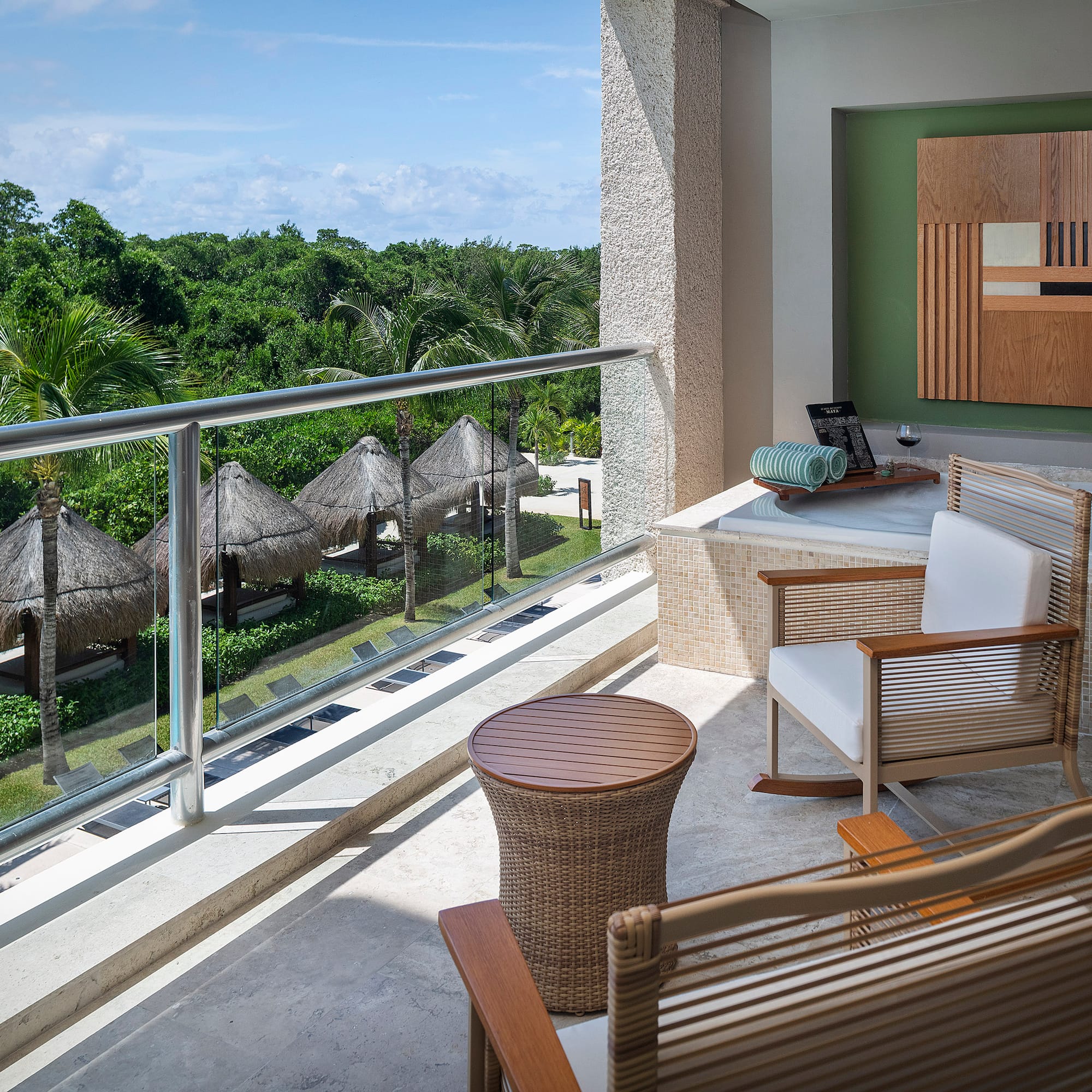 a balcony with chairs and a table.