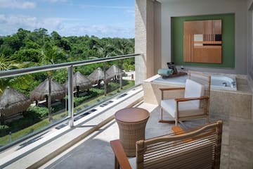 a balcony with chairs and a table.